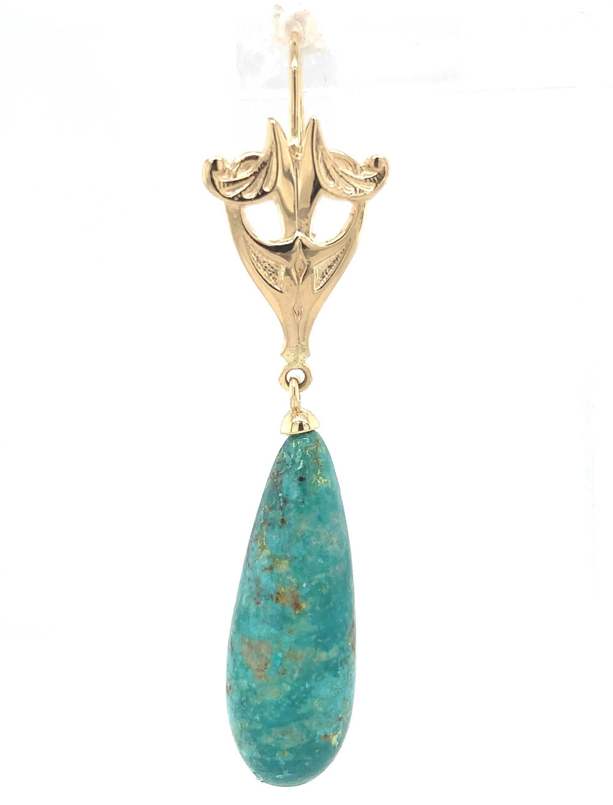 14k yellow gold earrings featuring a pair of large turquoise smooth briolettes weighing over 47 carats total weight. The turquoise hangs from Art Nouveau era casting newly made from the antique molds.  The turquoise are a mottled light to dark green