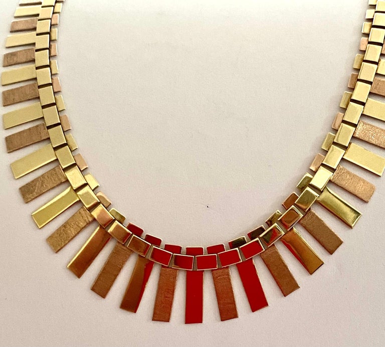 An original vintage 14K. red and yellow gold slatted necklace.
Front: matte and poly parts.
Back: poly.
Made in Germany ca 1965
Weight: 26.64 grams
length: 45.5 cm = 17.5 inch (this necklace can also be worn on a closed turtleneck sweater)
This type