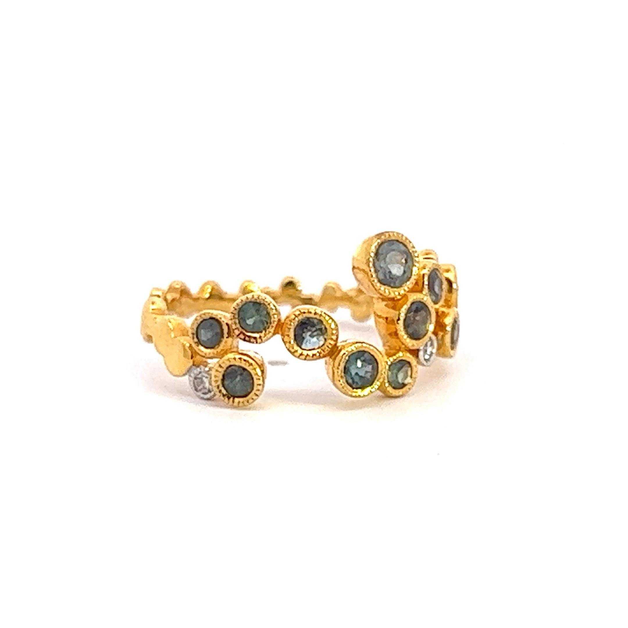 A wonderfully unique asymmetrical setting of mesmerizing round alexandrites and three small diamonds in 14k yellow gold. The alexandrites have great color change and weigh .89 ctw, and the diamonds .08 ctw. Size 6, but can easily be resized.