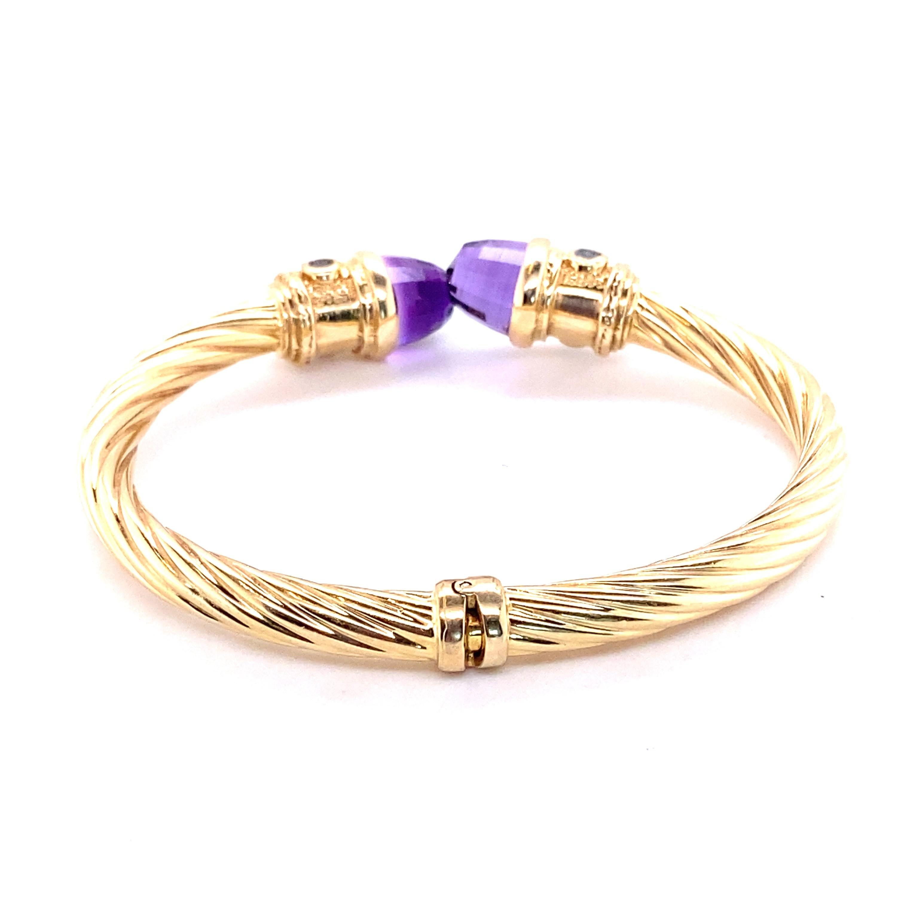 14K yellow gold bangle bracelet featuring amethyst terminals and bezel-set blue stones. The bangle measures approximately 6.5 inches in circumference and 6.00 mm in width. 

A great summer staple piece with a classic twisted cable design!