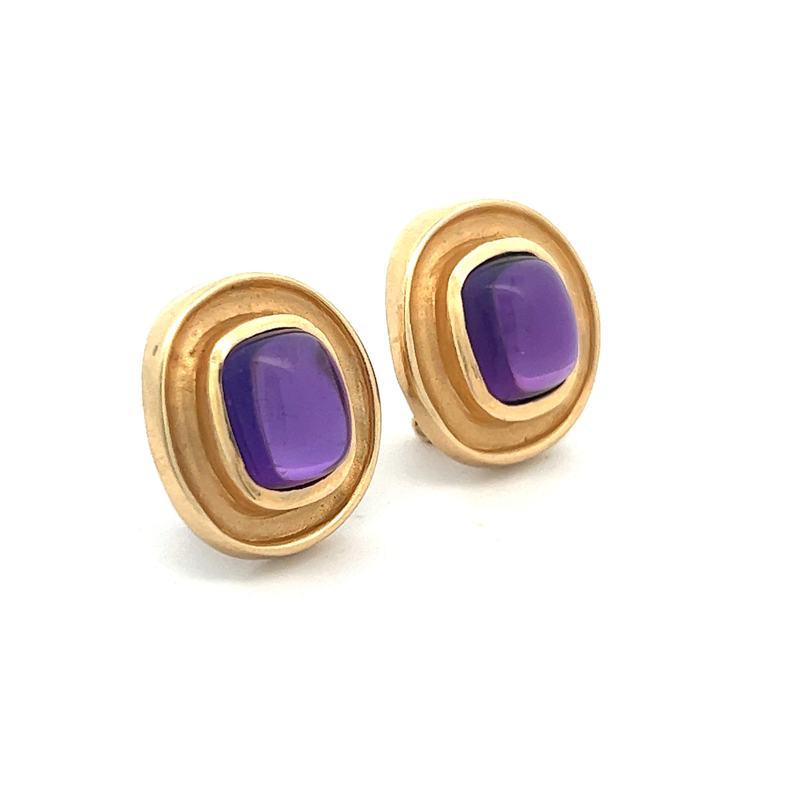 A beautiful pair of cabochon amethysts set in 14k yellow gold French clip earrings. The earrings are approximately 0.75 inches tall and the amethysts within weigh approximately 4.5 cts each (9 ctw). 