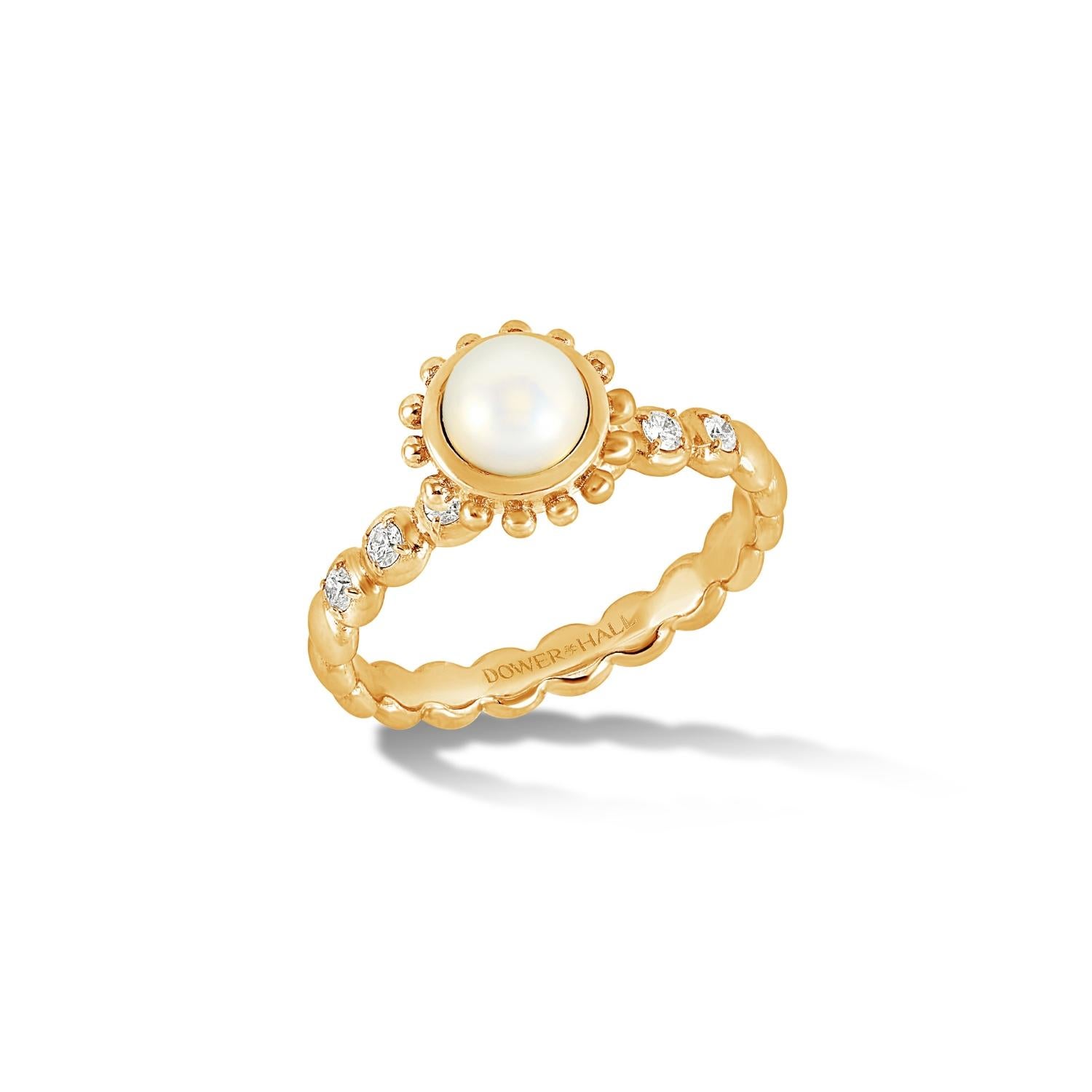 This striking ring is set with a round White Pearl in 14k yellow gold featuring granulated balls around the outside of the rub-over setting and with diamonds claw set in the dotty style band. Inspired by creatures of the coral reef, this colourful
