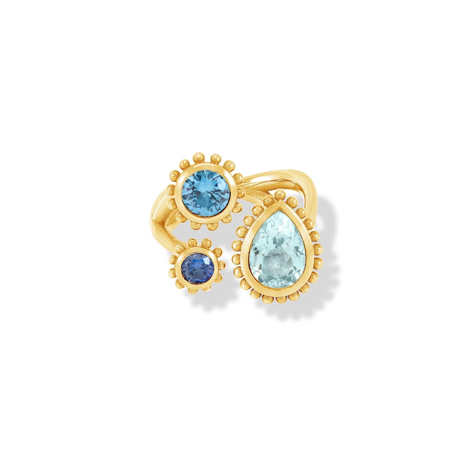 This dramatic and directional ring is set with three stones in 14k yellow gold featuring granulated balls around the outside of the rub-over settings. Inspired by creatures of the coral reef, this colourful Anemone collection is fascinating in its