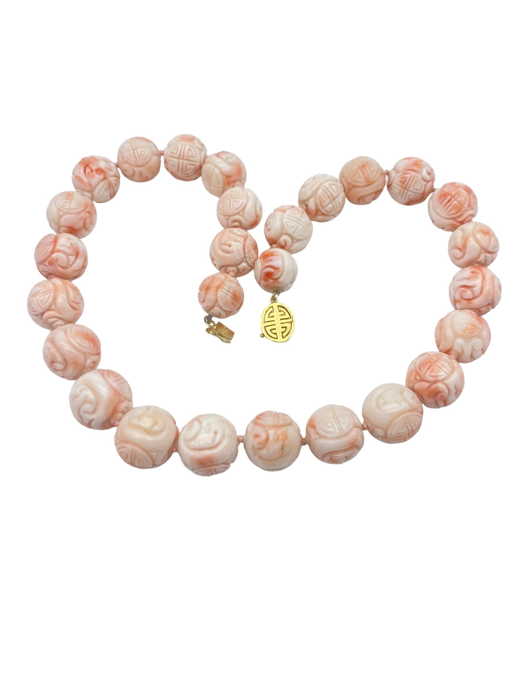 Exceptional carvings on every bead are individually carved with expressive artistry. The deep colors of desirable coral are interestingly expressed in the carvings. The strand is 18 inches long and has a gold 14-karat clasp measuring 14 mm. 
The
