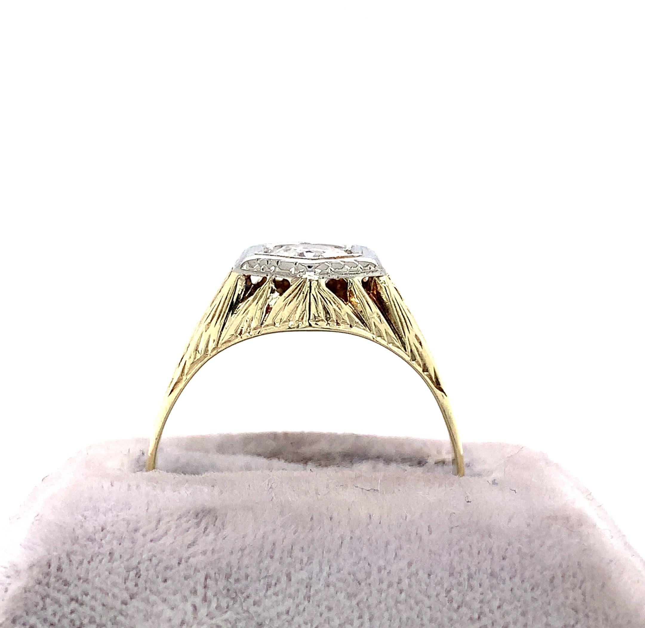 14K yellow gold Art Deco men's ring with a European cut diamond set in 18K white gold top. The diamond weighs .66ct and measures about 5.5mm. The diamond has SI-1 clarity and H-I color. The setting is all hand engraved. The ring fits a size 10