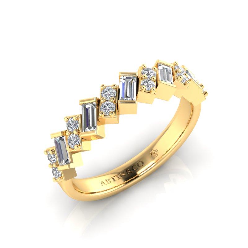 Crafted in 14K Gold, this chic unique design would make a super cool wedding band. The baguette diamonds are set on a slant and there are two prong set round diamonds in between alternating with the baguette to create this modern design. 

Gold