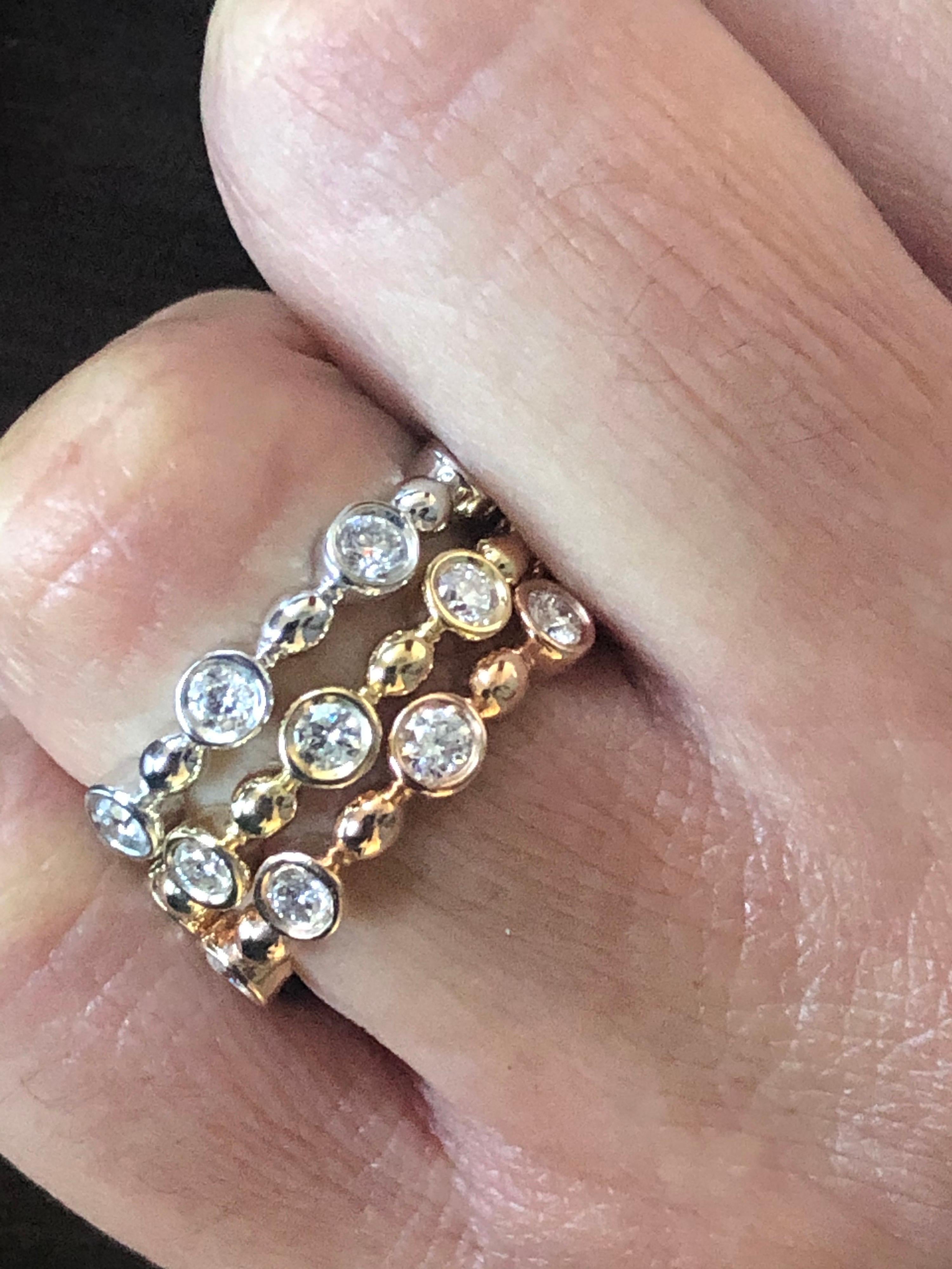 White, Yellow, Rose gold diamond eternity rings set in a bezel. The total carat weight of each ring is 0.64 carats. The stones are G-H color and the clarity is SI. The rings are sold as a set.