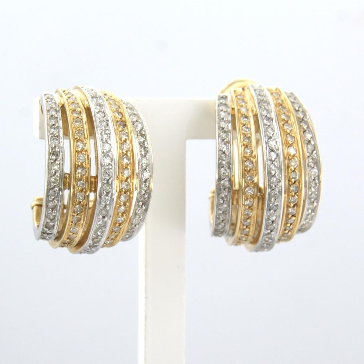 Modern 14k bicolour gold ear clips set with single cut diamonds up to . 0.80ct