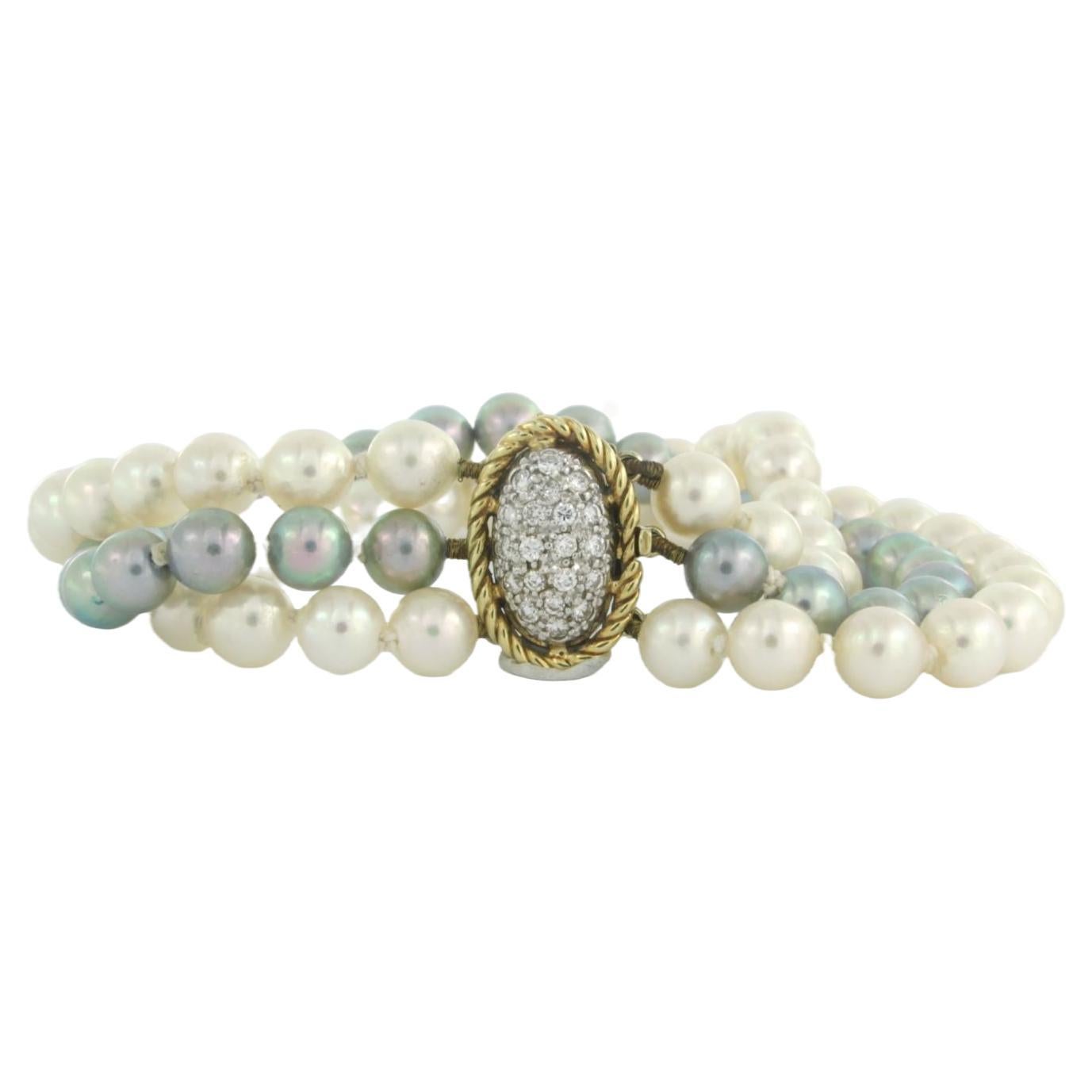 14k bicolour gold lock with diamonds on a 3-row pearl bead bracelot 