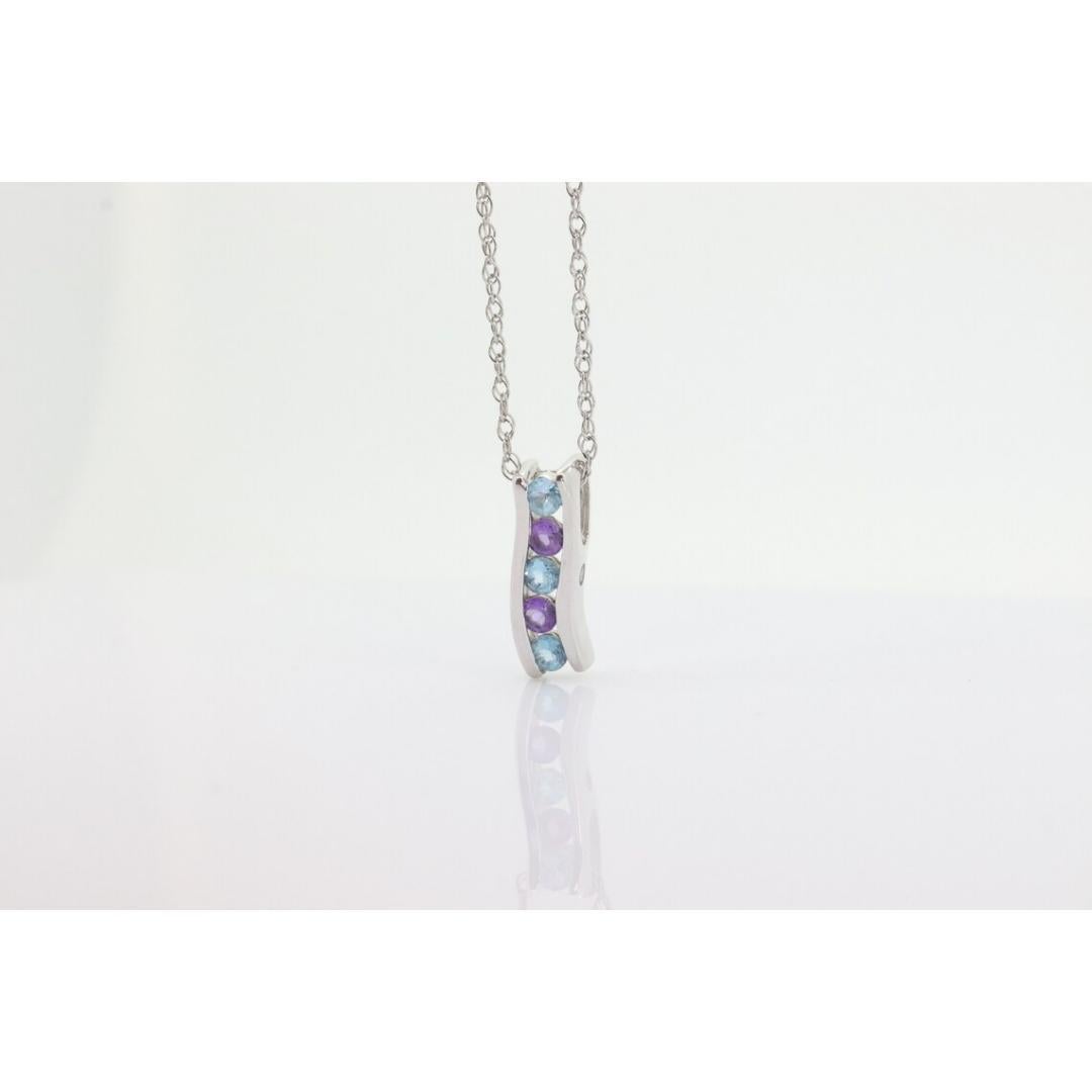 Vintage
Materials: Gold

Gemstone: Topaz

This is truly a stunning Candy pendant. Journey Pendant with Topaz, Amethyst and Diamonds on the sides.

All on a 14k White Gold Box Chain necklace 18in 1mm width

Condition: Shows no signs of