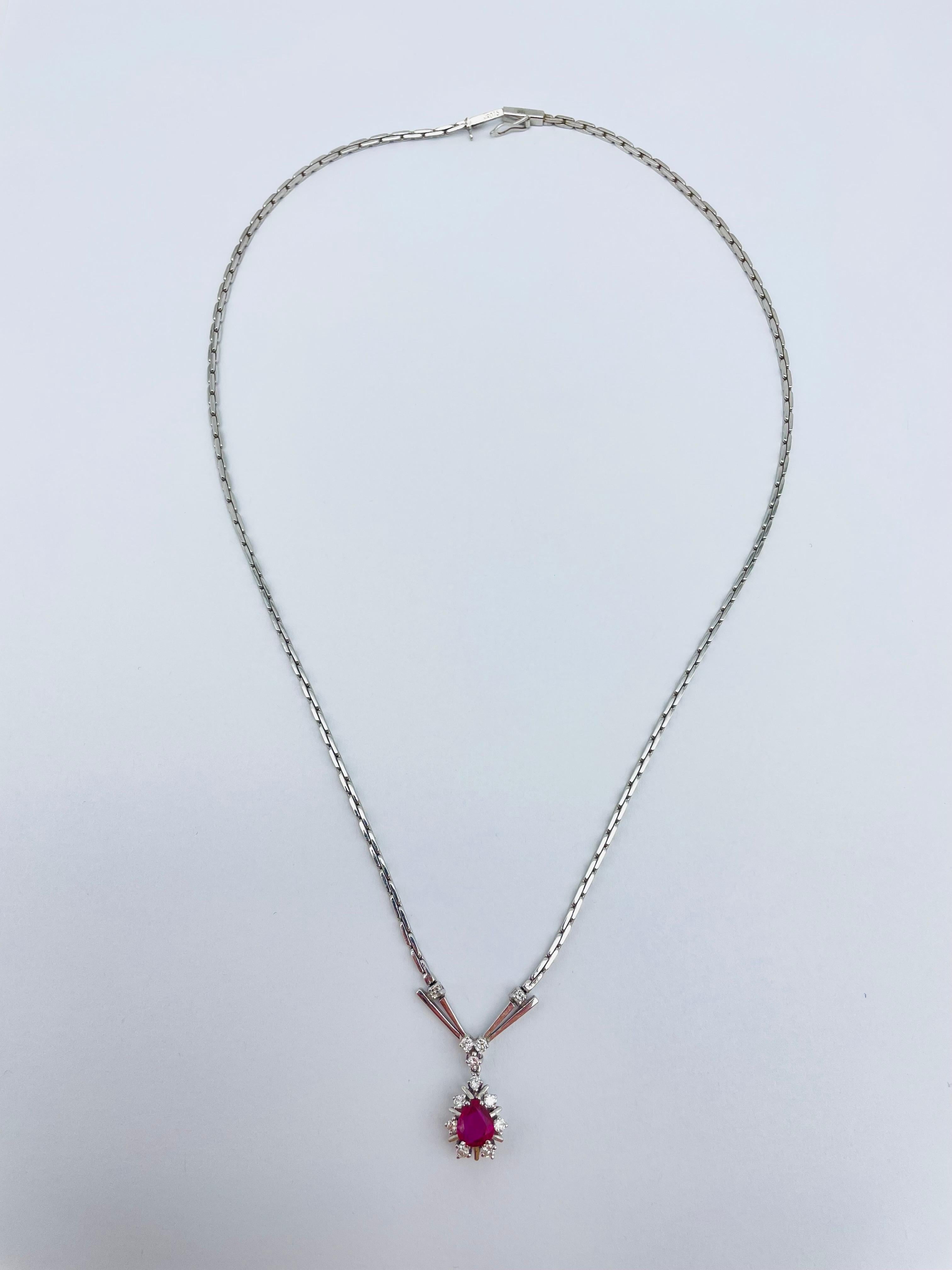 Adorn yourself with this dazzling 14k white gold necklace that exudes pure elegance and sophistication. The pendant features a stunning red colored stone, adding a touch of color and vibrancy to your look. The stone is expertly cut and polished to