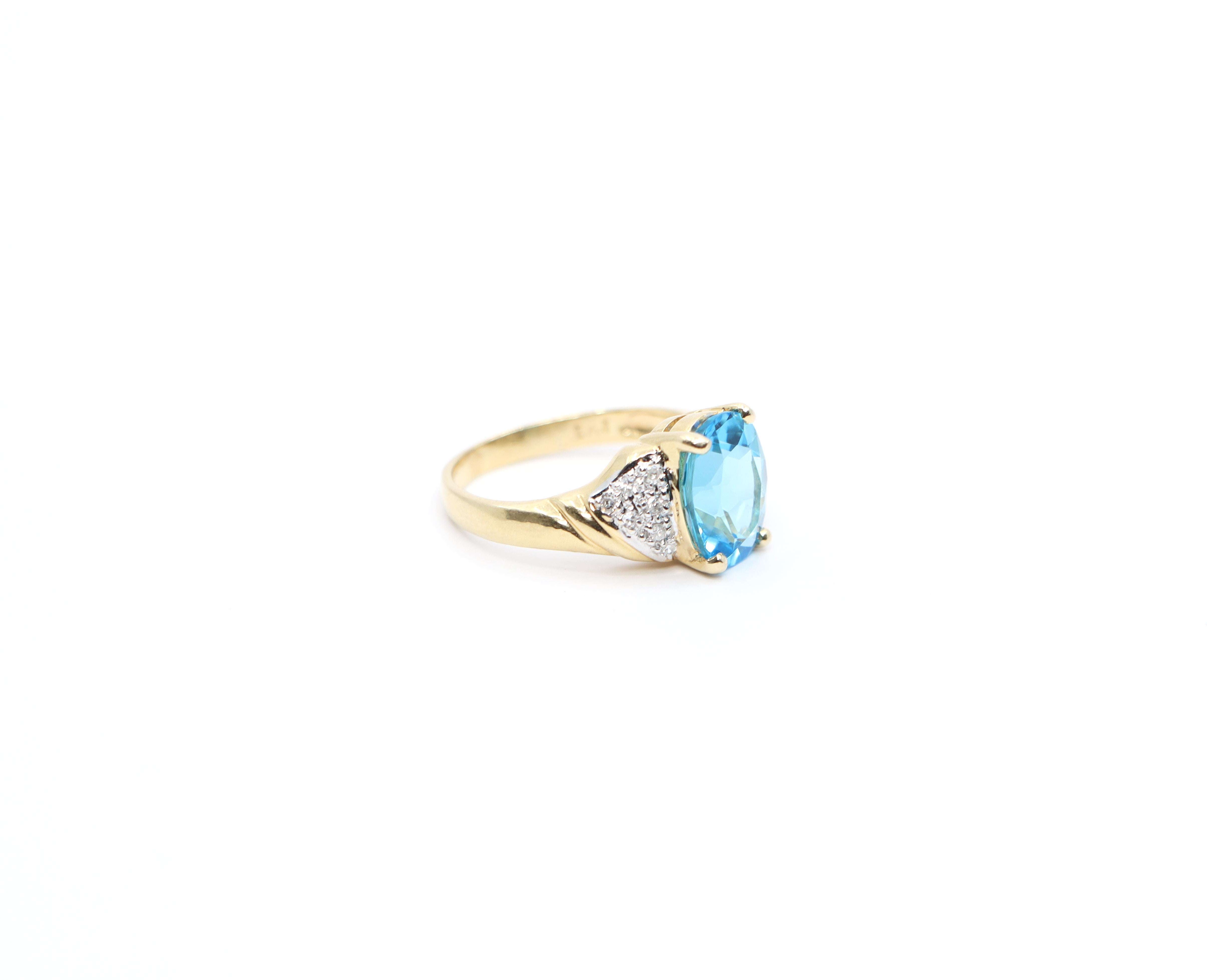 Gold Type:
14k Yellow Gold

Size:
4.75

Gemstone:
Oval cut 3.11 ct brilliant Blue Topaz, accented with 14 round brilliant cut shoulder Diamonds

Weight:
3.2g

Era:
Vintage

Condition:
Excellent Vintage Condition.  Minor signs of age-related