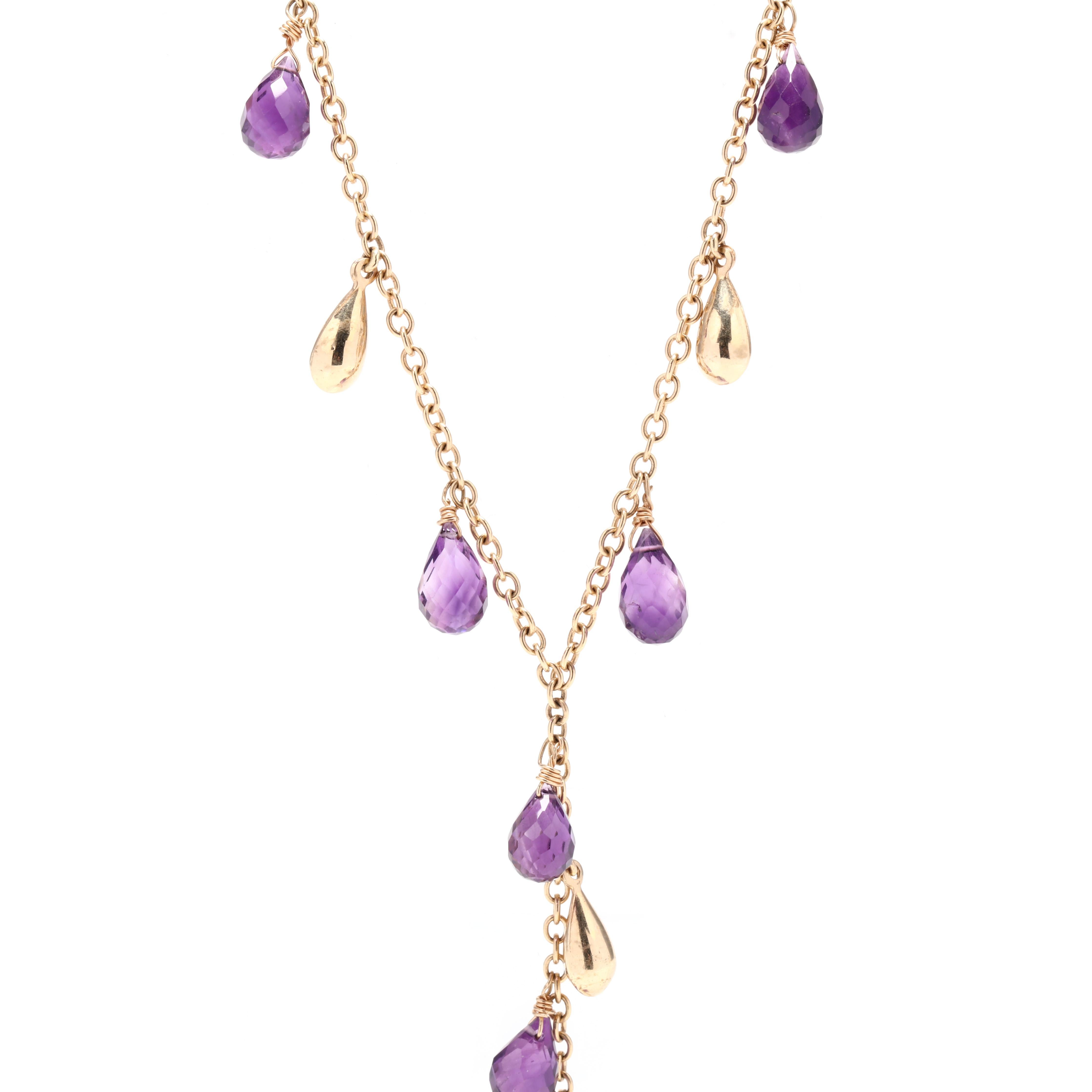A vintage 14 karat yellow gold amethyst fringe lariat necklace. This necklace features gold teardrop bead and amethyst briolette dangles in a lariat motif suspended from a cable chain.



Stones:

- amethyst, 11 stones

- teardrop briolette

- 8.5 x