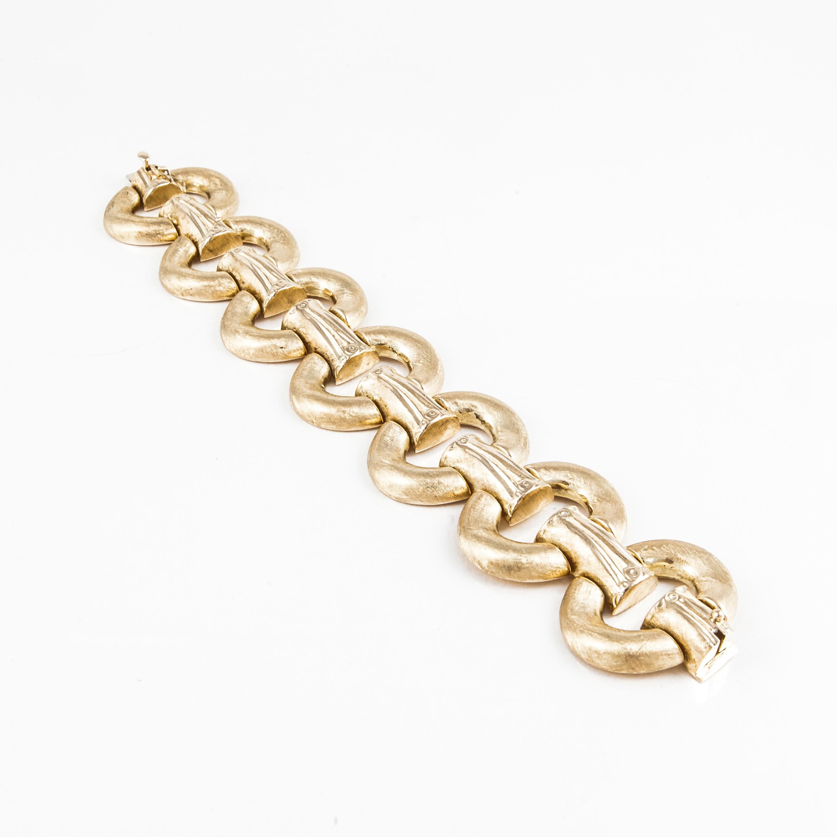 Large oval link bracelet composed of 14K brushed yellow gold.  It is marked 