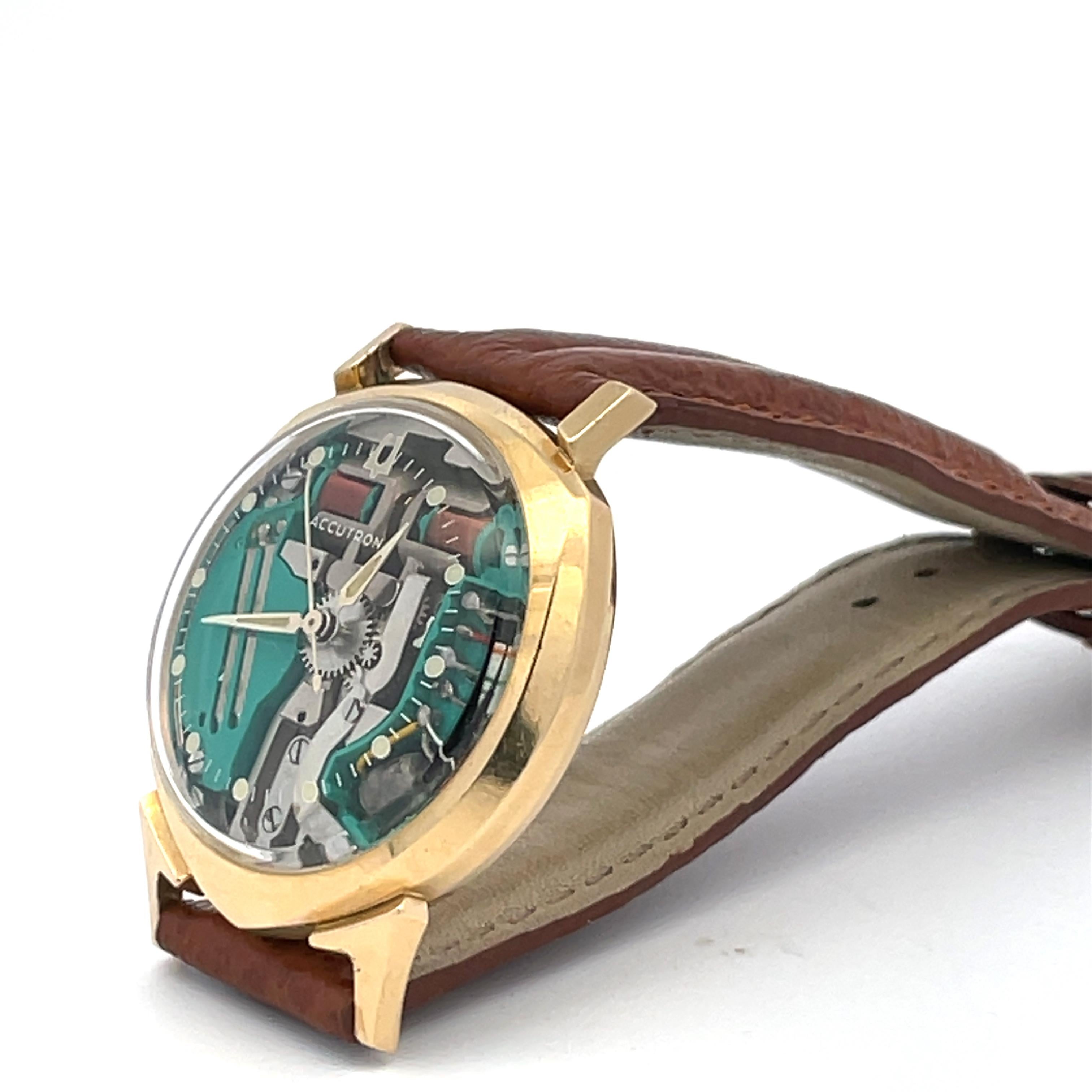 Extremely rare 14K solid yellow gold vintage Bulova Accutron asymmetrical Spaceview ‘Alpha’, dated 1961, with the shield-shape case, and signature visible jade movement. The electro-mechanical battery powered movement, pioneered by Bulova, is in