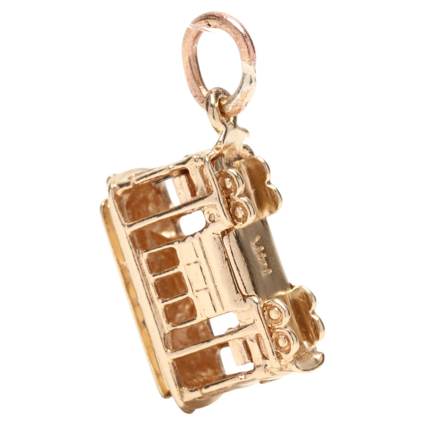 A vintage 14 karat yellow gold cable car charm. This charm features a cable car motif with cut out windows and doors and a thin gold bail.



Length: 3/4 in.



Width: 3/8 in.



Weight: 1.90 dwts.