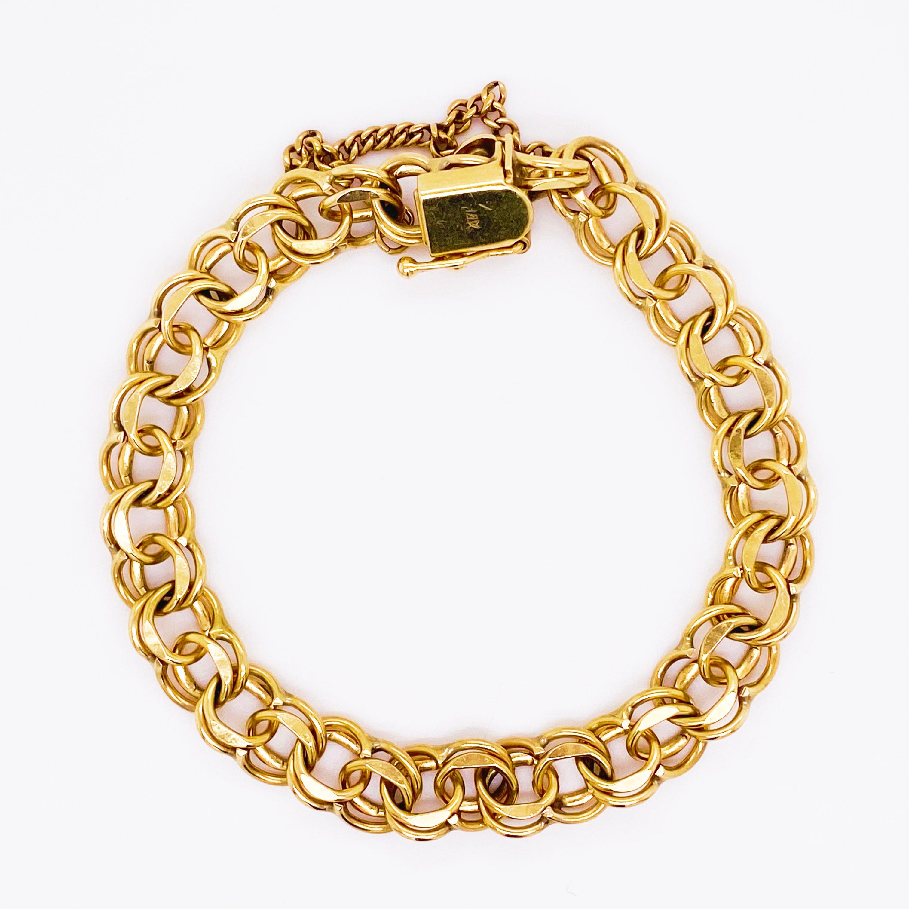 This is a handmade double link estate charm bracelet and it was made the old fashion way-heavy links and sturdy! Each link was handmade and put together to make this gorgeous, double link design. The bracelet is solid 14 karat yellow gold with a
