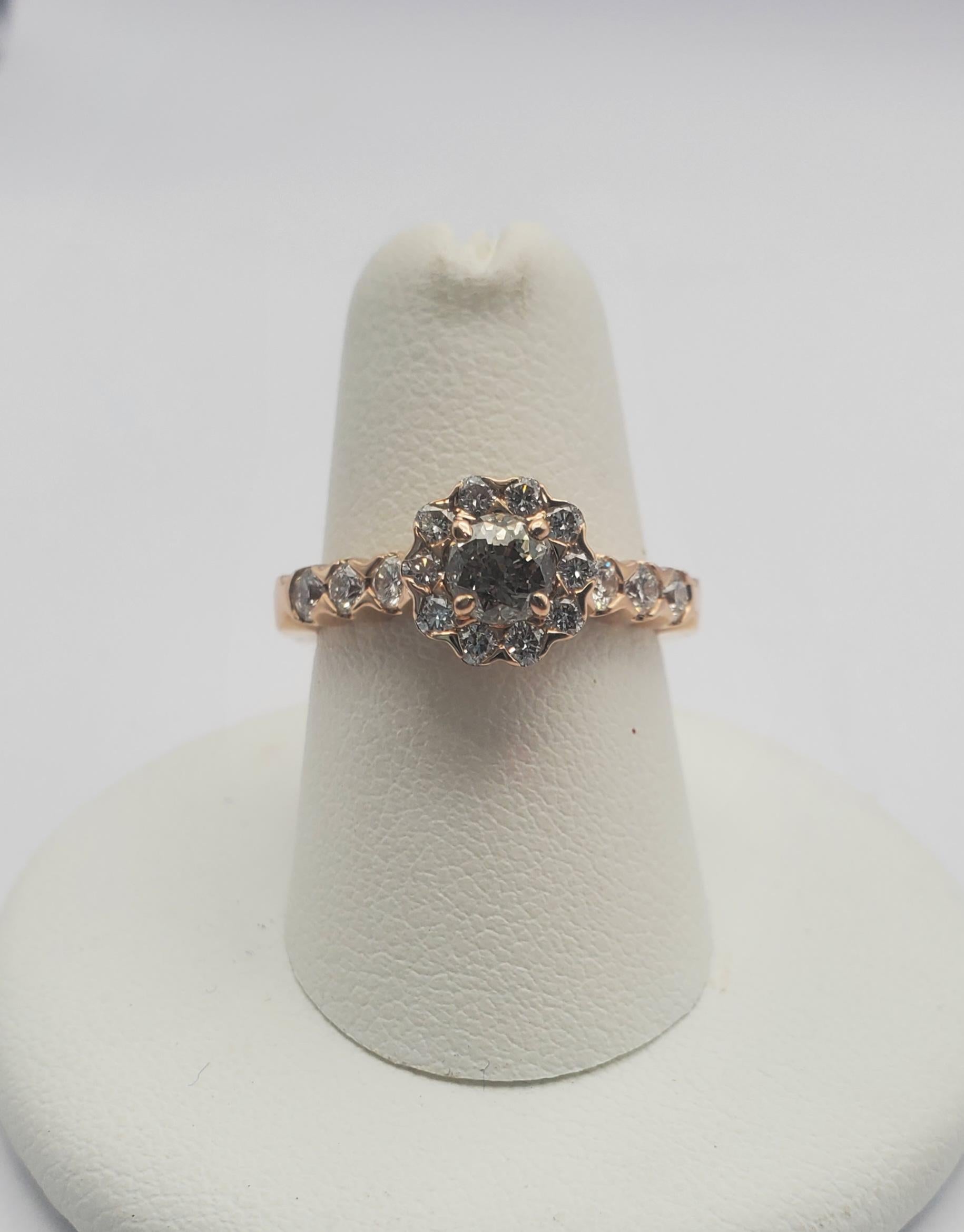 Stunning chocolate brown round diamond halo rose gold engagement ring. The center stone is a 0.40ct round chocolate diamond, surrounded by a halo of white diamonds. The chocolate diamond is C5 in color and SI1 in clarity. The white diamonds in the