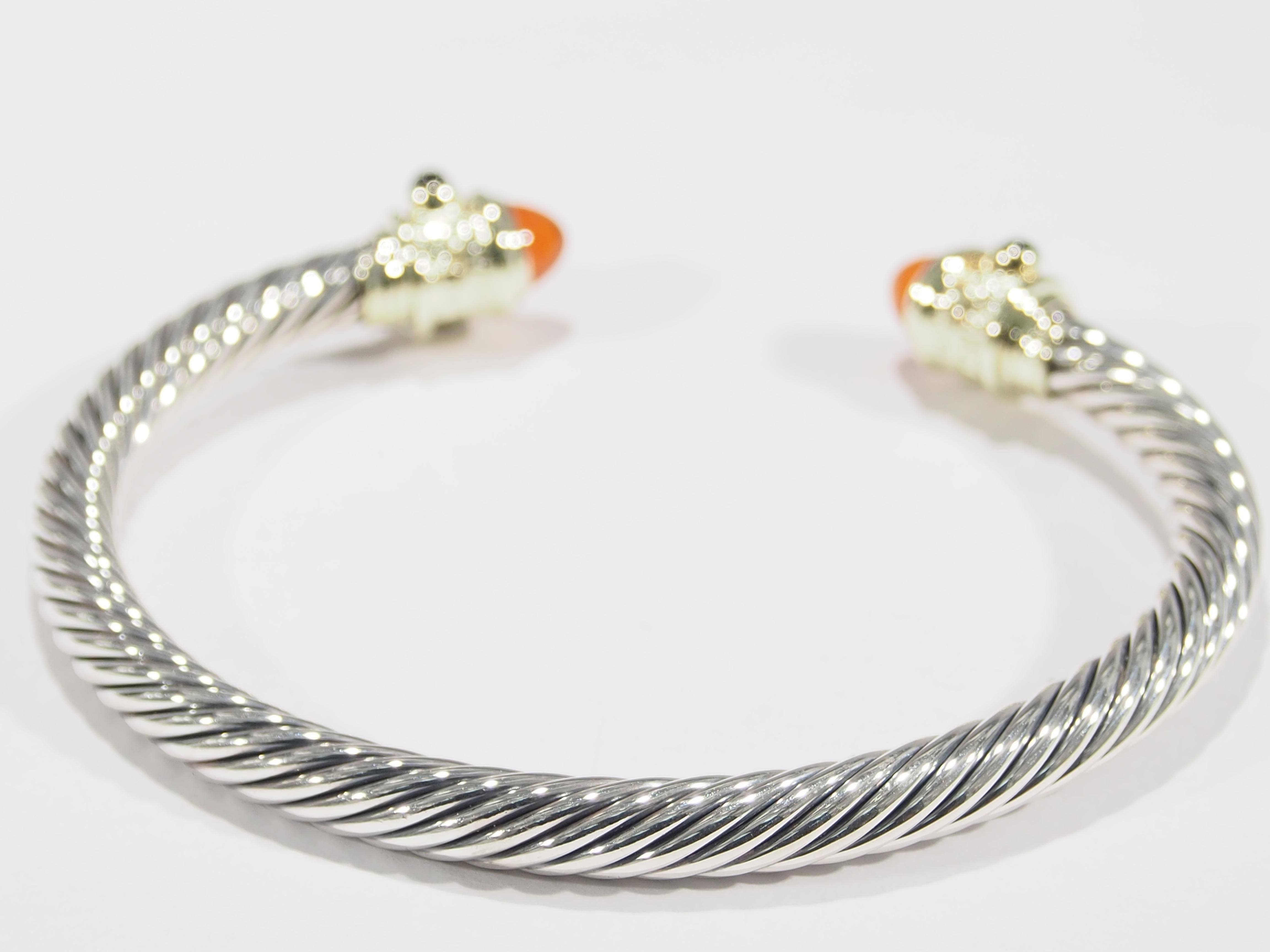This bangle is classic David Yurman bangle from the Cable Classic Collection. The 14k and SIlver bangle is set with Citrine Cabachon Cut and Onyx stones. It measure approximately 6 inches on the inside and weighs 6.06 grams. A delightful and classic