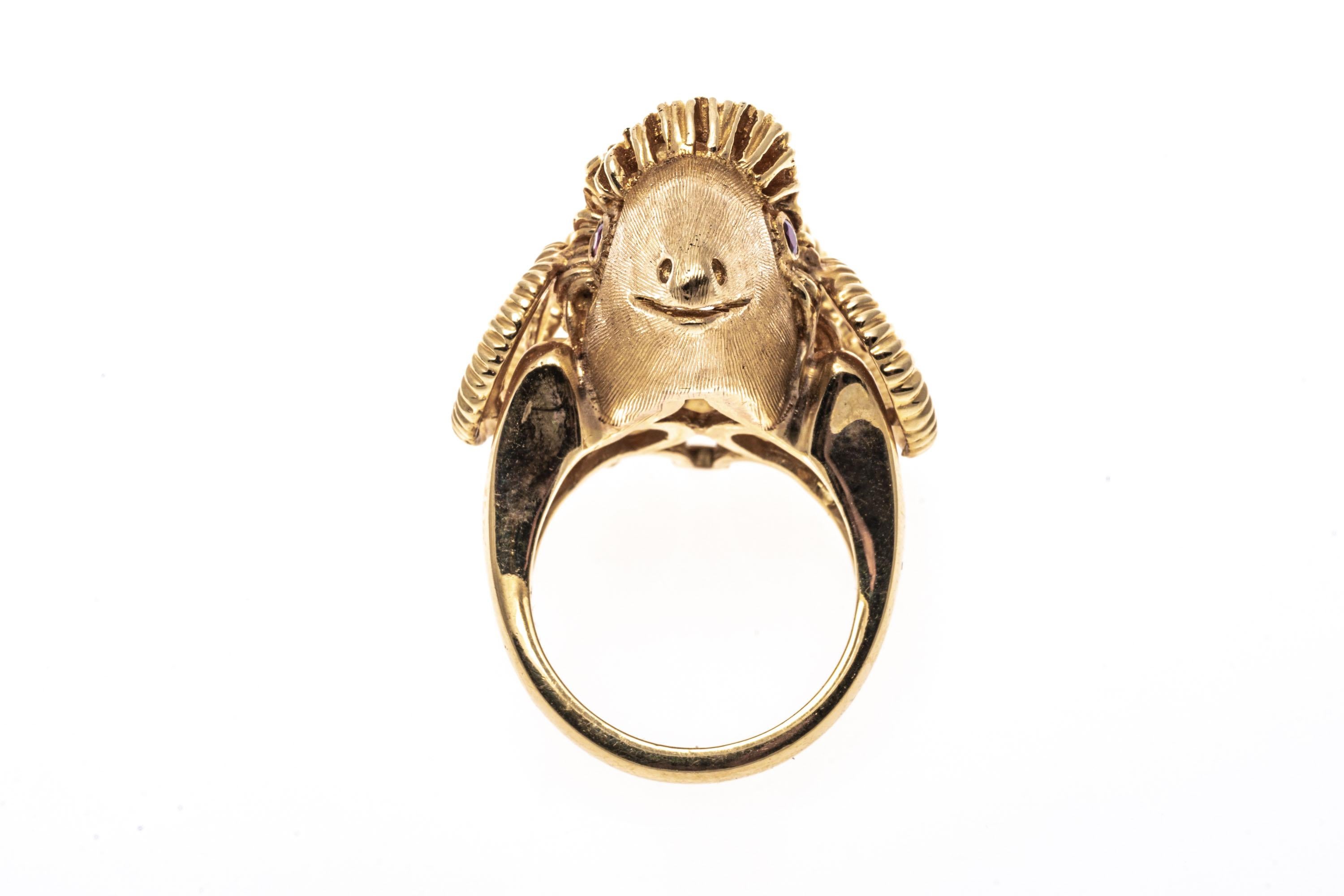 14k Yellow Gold Detailed Rams Head Ring With Ribbed Horns & Rubies
This imposing ring is a detailed figural ram's head, with ribbed, curved horns, a brushed face, and faceted ruby eyes.
Marks: 14k 
Dimensions: 7/8