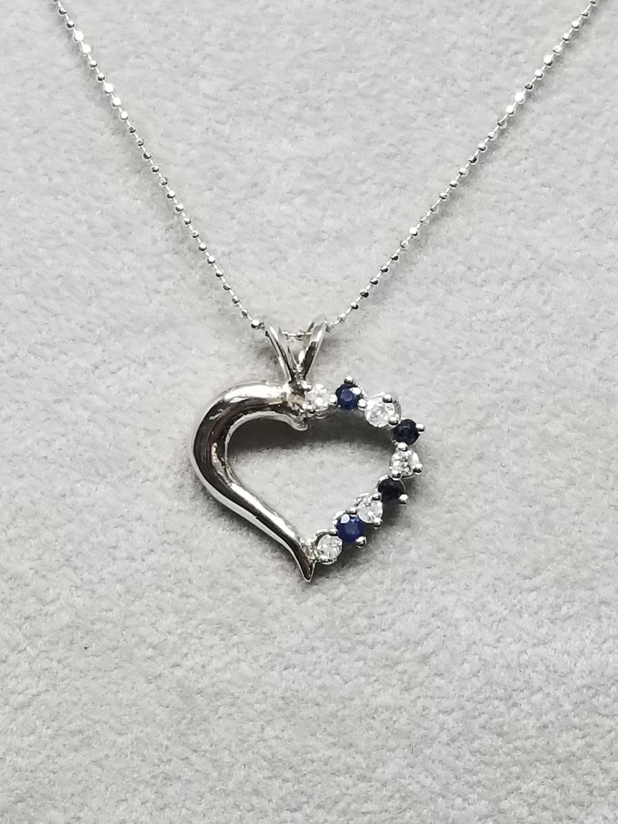 14k white gold diamond and sapphire containing 5 round full cut diamonds of very fine quality weighing .20pts. and 4 round sapphires weighing .30pts. on a 16 inch chain.