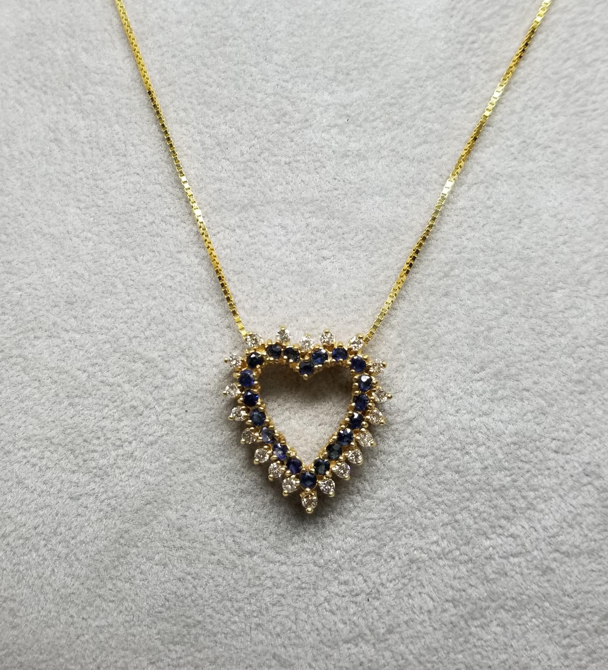 14k yellow gold diamond and sapphire heart containing 20 round full cut diamonds of very fine quality weighing .60pts. and 20 round sapphires weighing 1.10cts. on a 16k inch chain.