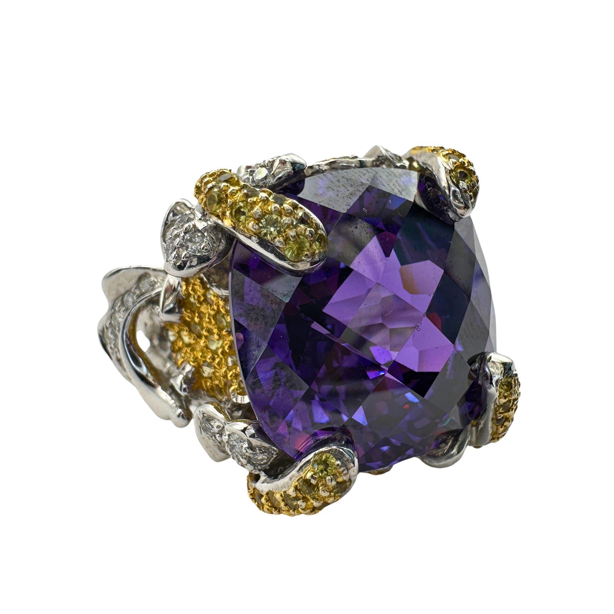Indulge in luxury with our 14k Diamond and Yellow Sapphire and Purple Stone Center Cocktail Ring. Crafted in 14k White Gold, this exquisite ring boasts a total of 0.74 carats of sparkling diamonds, 1.08 carats of vibrant yellow sapphires, and a