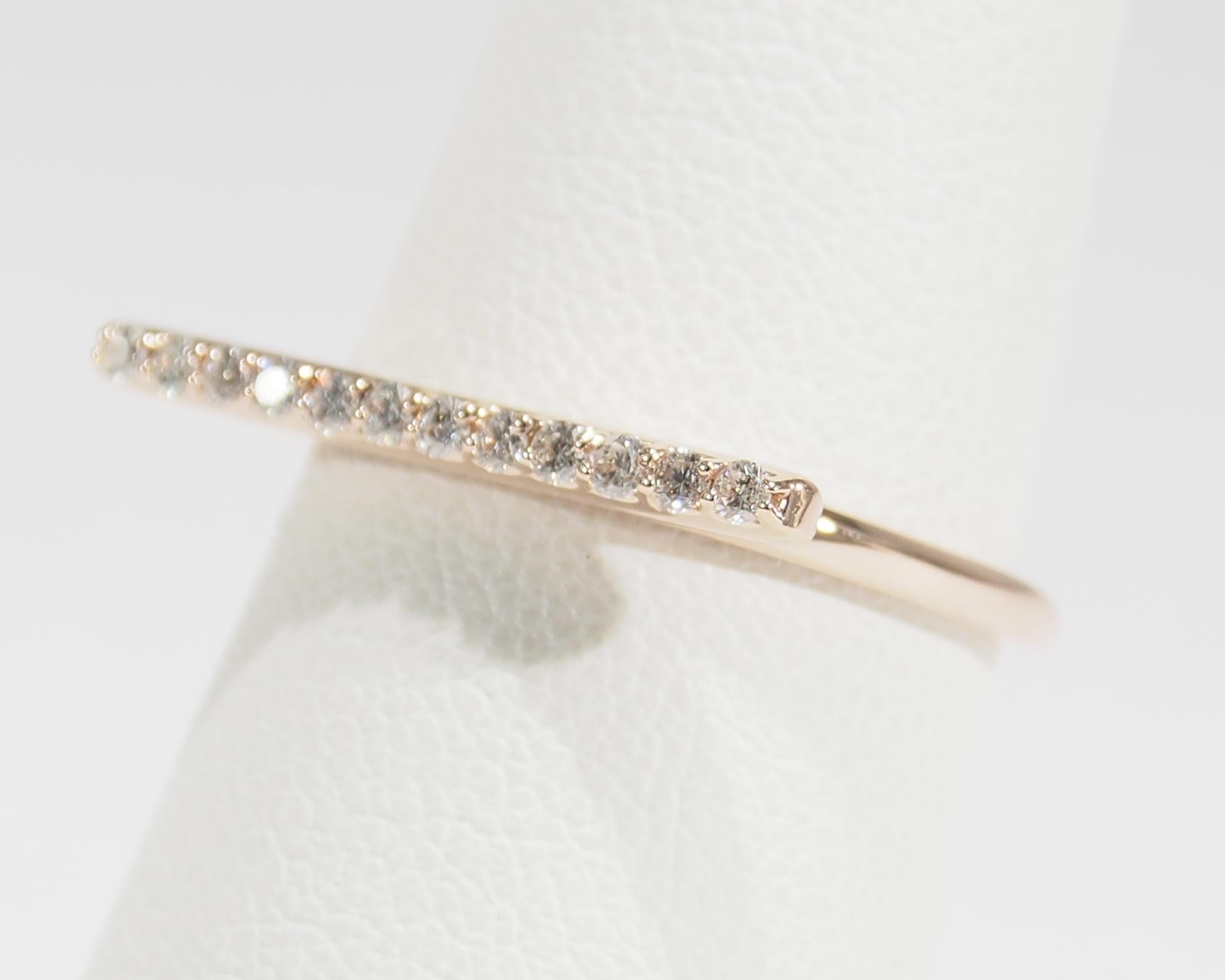 This is a delightful 14K Rose Gold Ring fashioned with Diamonds set in a horizontal Bar. There are (12) Round Brilliant Cut Diamonds, approximately 0.20ctw, G-H in Color, VS-SI in Clarity set in the 3/4 of an inch Bar. Fabricated in Italy, this
