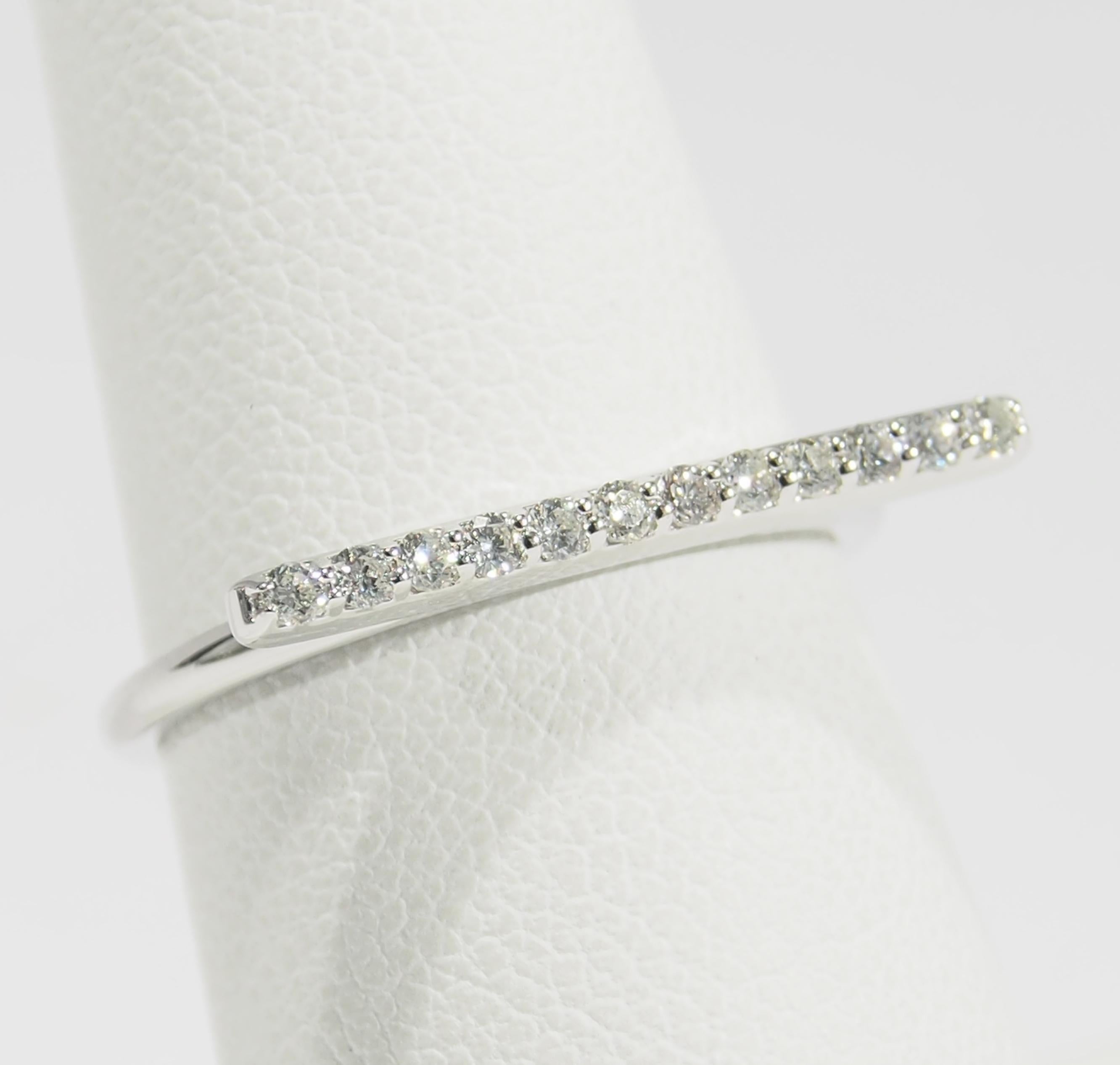 This is a delightful 14K White Gold Ring fashioned with Diamonds set in a horizontal Bar. There are (12) Round Brilliant Cut Diamonds, approximately 0.20ctw, G-H in Color, VS-SI in Clarity set in the 3/4 of an inch Bar. Fabricated in Italy, this