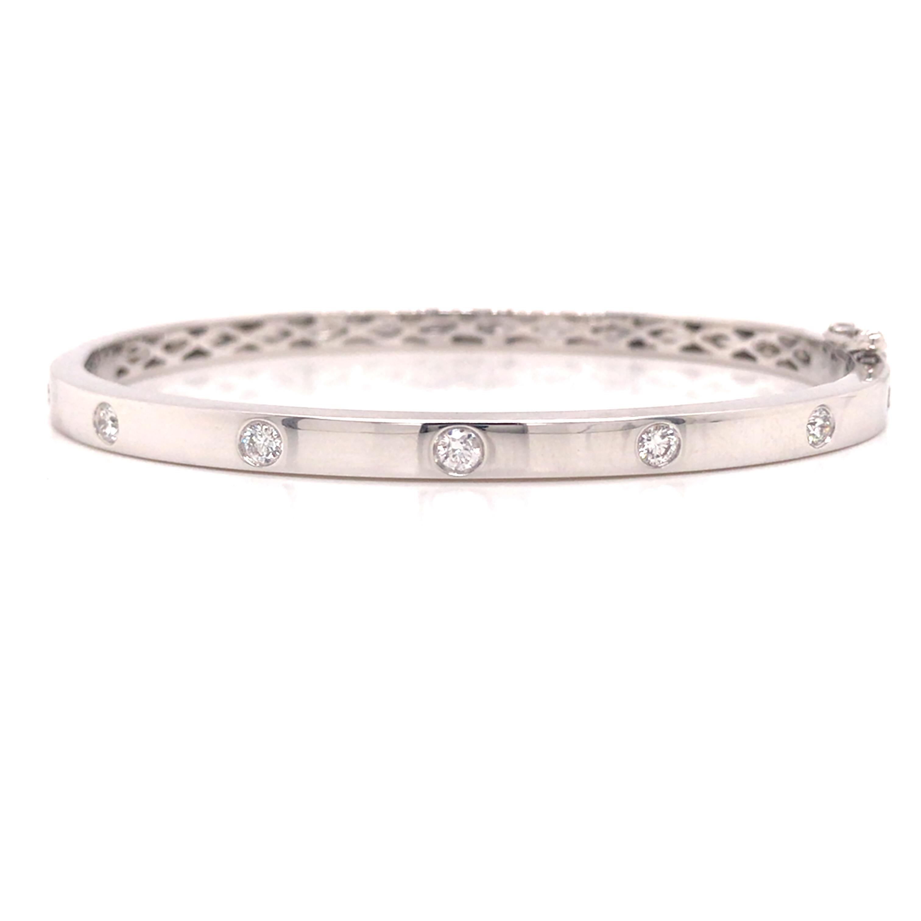 Diamond Bevel Bangle Bracelet in 14K White Gold.  (7) Round Brilliant Cut Diamonds weighing 0.45 carat total weight, G-H in color and VS-SI in clarity are expertly set.  The Bangle measures 6 1/2 inch inner circumference and 3/16 inch in width. 