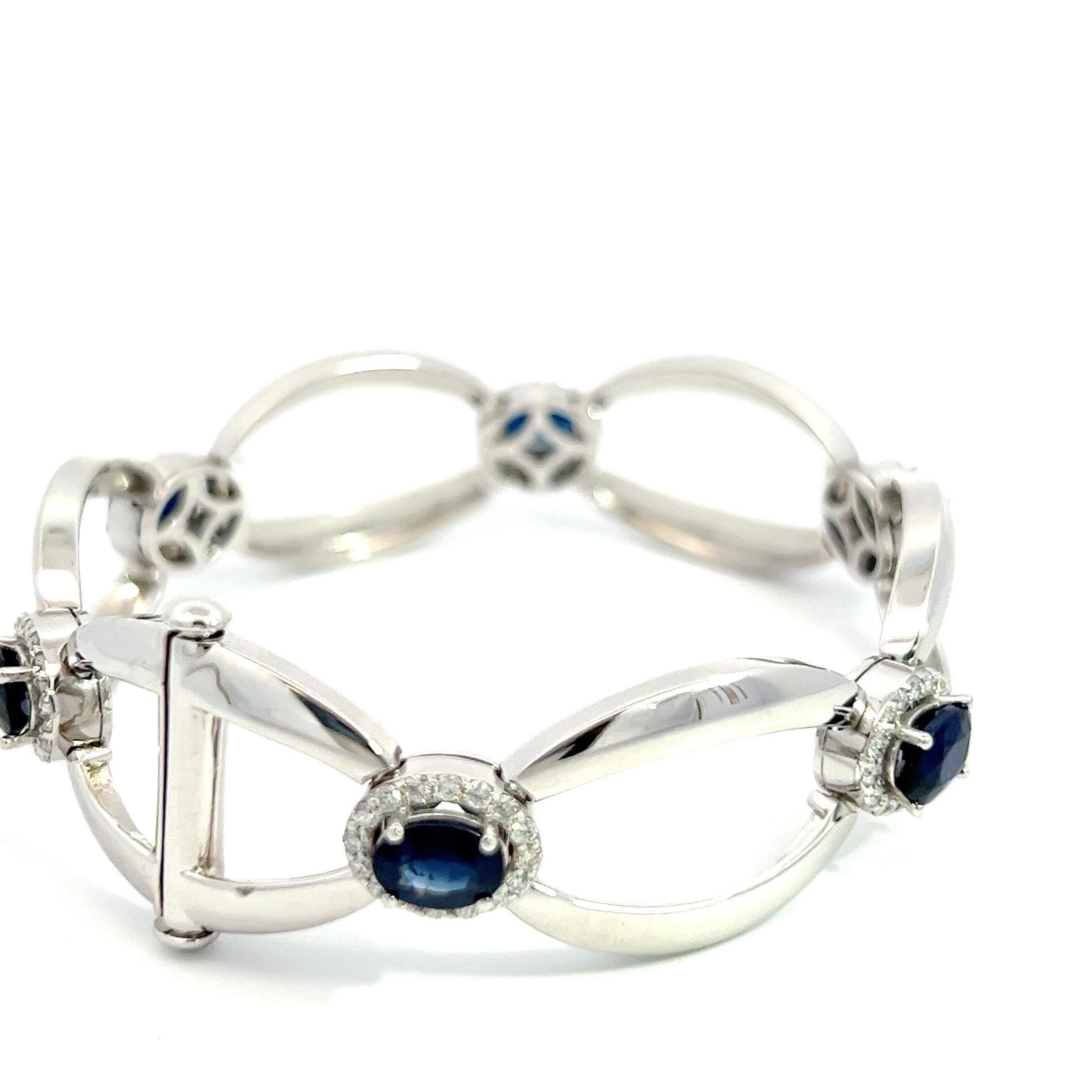 Embrace the allure of timeless elegance with this exceptional bracelet, proudly made in the USA. Crafted with meticulous attention to detail, it showcases a harmonious union of unique diamonds and six resplendent royal blue natural sapphires. Set in