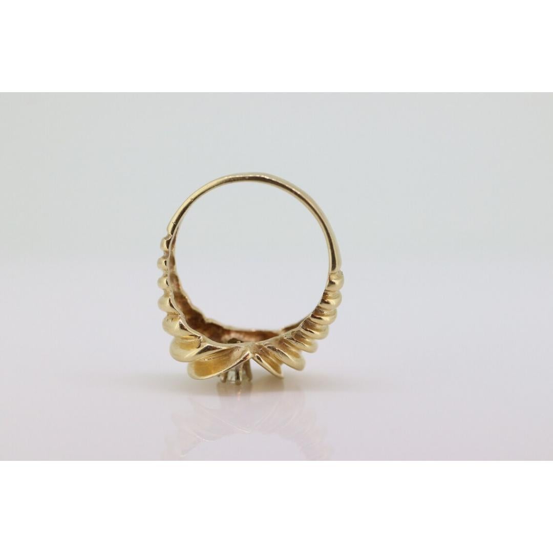Vintage from the 1980s
Materials: Stone
Gemstone: Diamond
Gem Color: Colorless
Band Color: Gold

Style: Avant garde

Unique vintage Ring. Bypass ring in a wave design.

Design in a form of Sfogliatella Pastry.

Condition: Has not been polished. Has