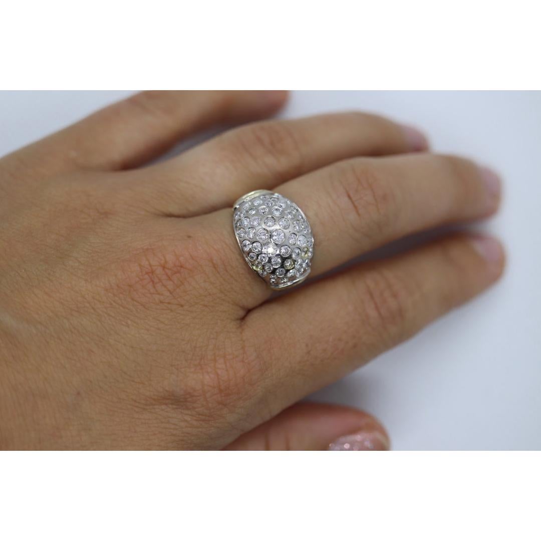 Vintage from the 1980s
Size: 7 US
Materials: Stone
Gemstone: Diamond
Gem color: Colorless
Band color: Gold

Style: Avant garde

Magnificent Contemporary style cocktail ring. Beautiful round diamond cluster bezel set into 14k white gold setting. Top