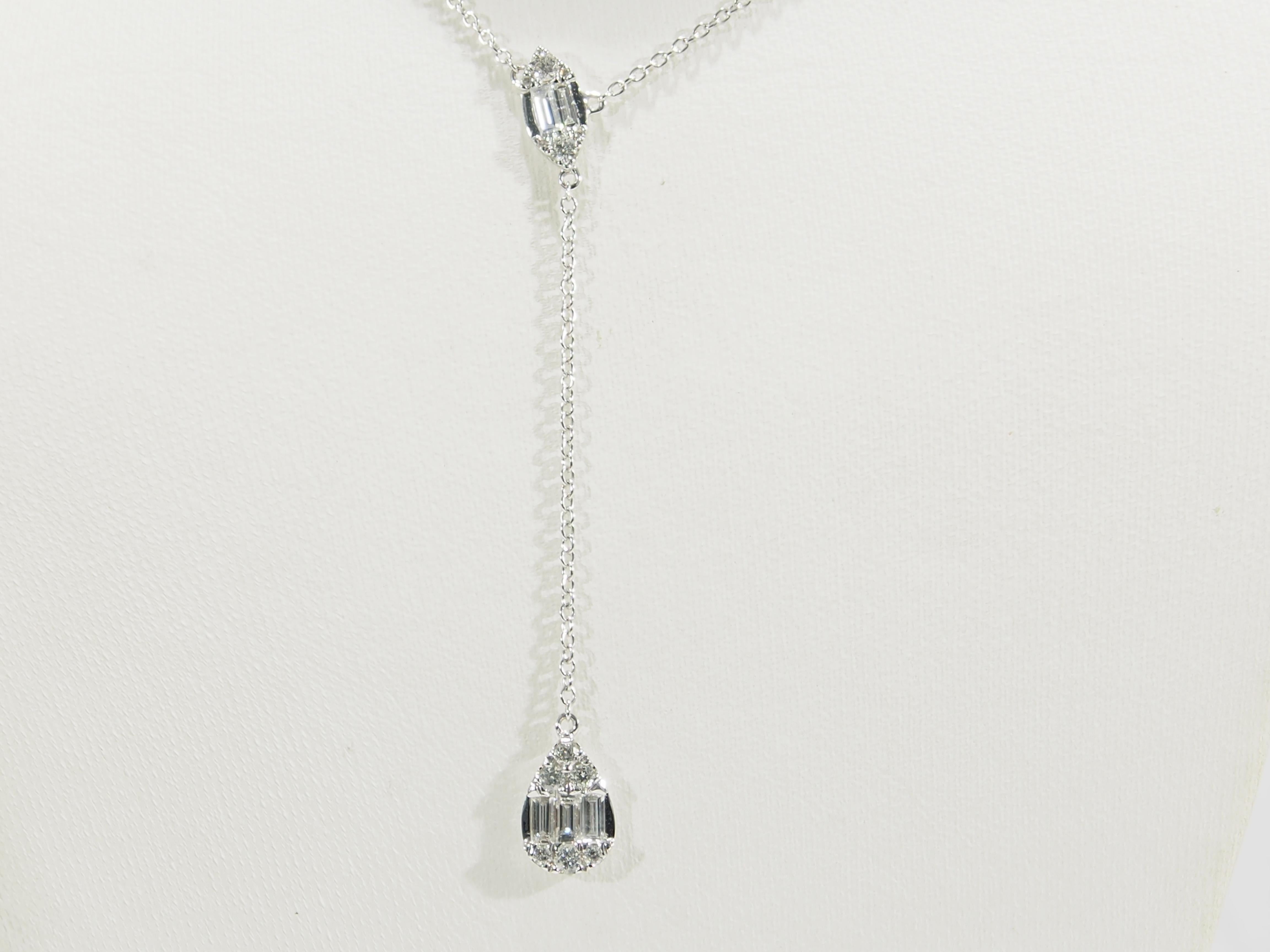 A 14k white gold and diamond Y Necklace.  Expertly set with (12) Round Brilliant Cut and (5) Baguette Diamonds, G-H in color, SI in clarity and approximately .48 carat total weight.  The Necklace is 17.5 inches long with a 1 inch extender, the Y
