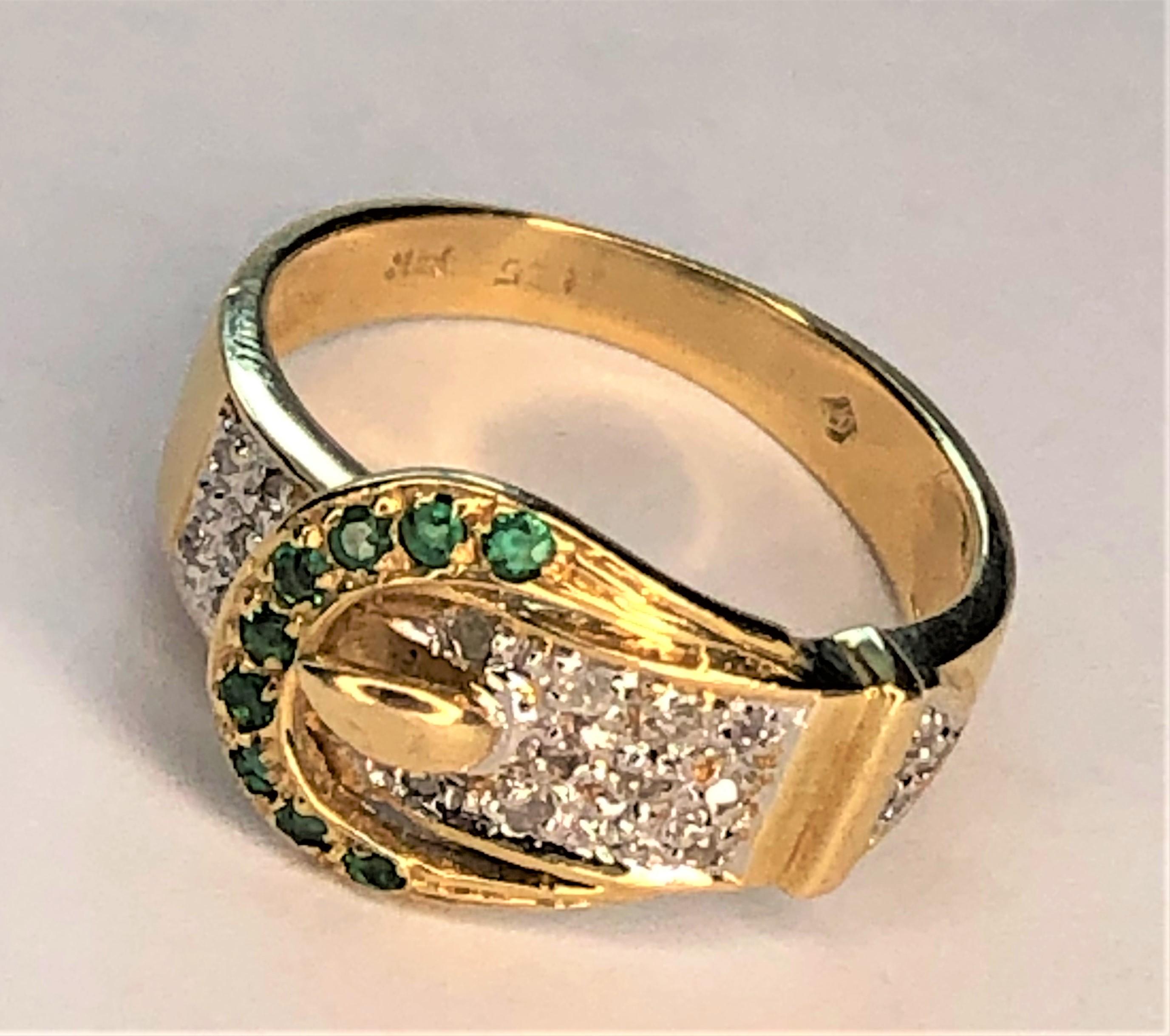 This unique ring is a great gift for anyone!
14 karat yellow and white gold with emeralds and diamonds.
9 round emeralds on part of the buckle.  
16 pave diamonds adorn part of the strap,
Approximately size 4.75 (can be sized).
Stamped 