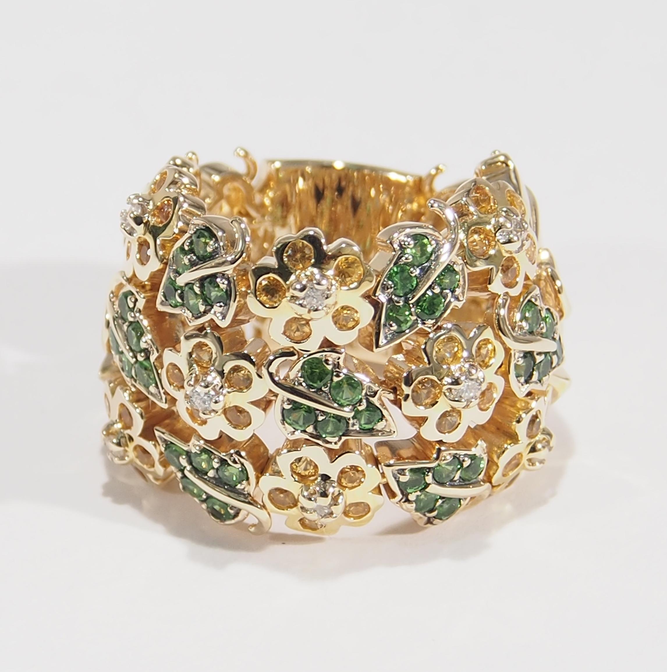 This is a delightful 14K Yellow Gold Band designed with Flexible Leaves and Flowers surrounding the finger. The leaves are accented with (35) Tsavorites, 0.70ctw, sprinkling with (40) Yellow Sapphire Flowers, 0.80ctw. that have (8) Round Brilliant