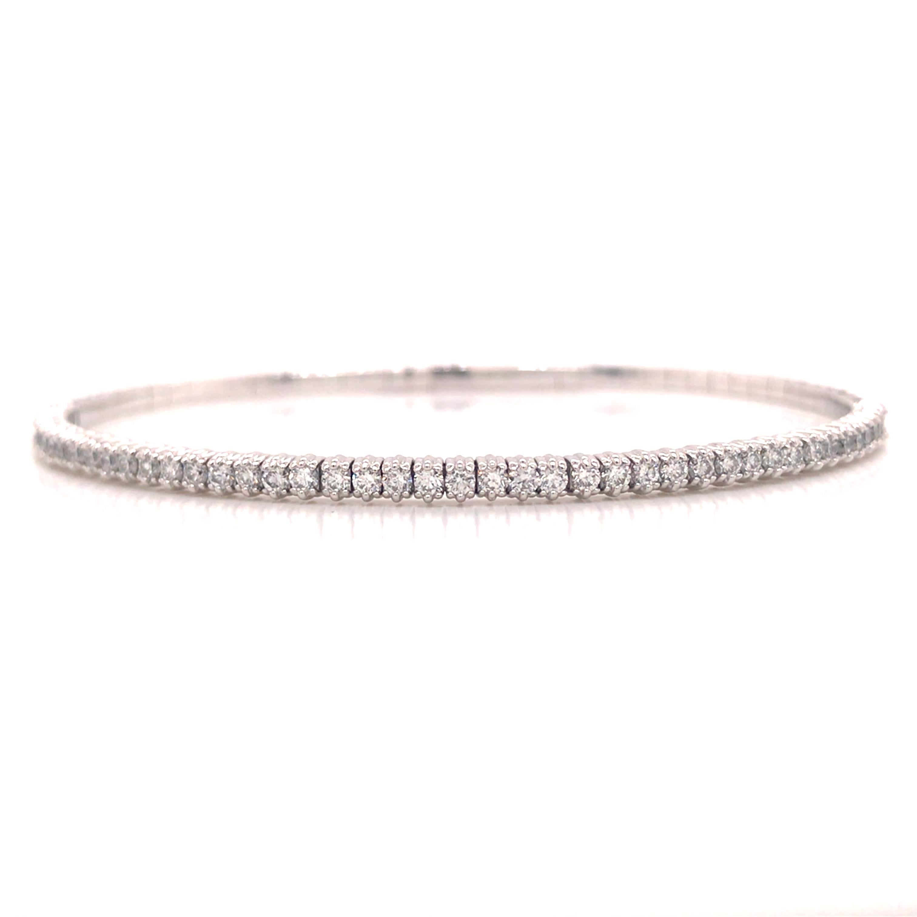 Diamond Flexible Bangle Bracelet in 14K White Gold.  Round Brilliant Cut Diamonds weighing 1.0 carat total weight, G-H in color and VS-SI in clarity are expertly set. The Bangle measures 6 1/2 inch and 1/8 inch in width.  6.98 grams.