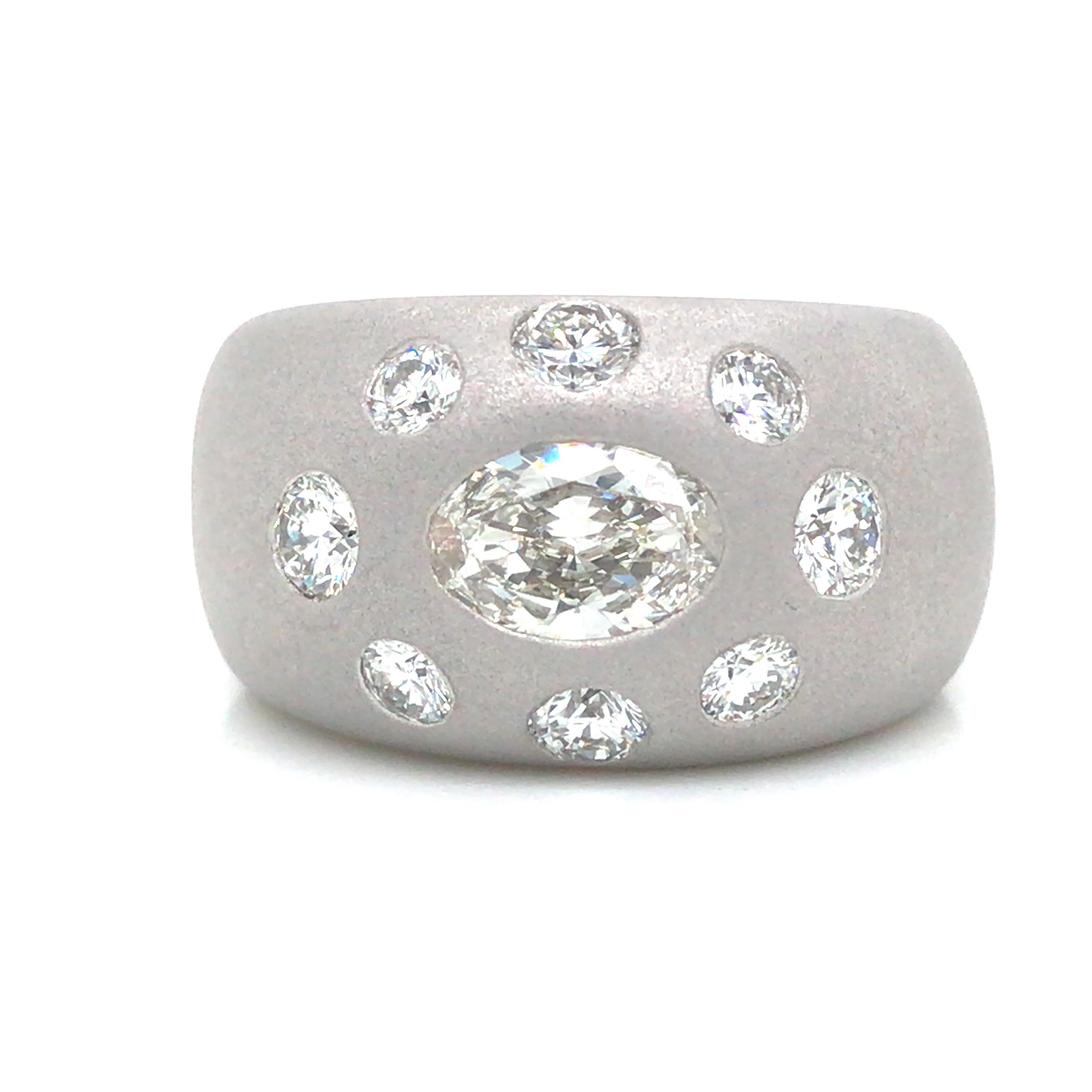 Diamond Gents Ring in 14K White Gold.  (1) Oval Diamond weighing 1.50 carats and (8) Round Brilliant Cut Diamonds weighing 1.50 carats F-H in color and VS1 in clarity are expertly set.  The Ring measures 1/2 inch in width.  Ring size 11.  29.5