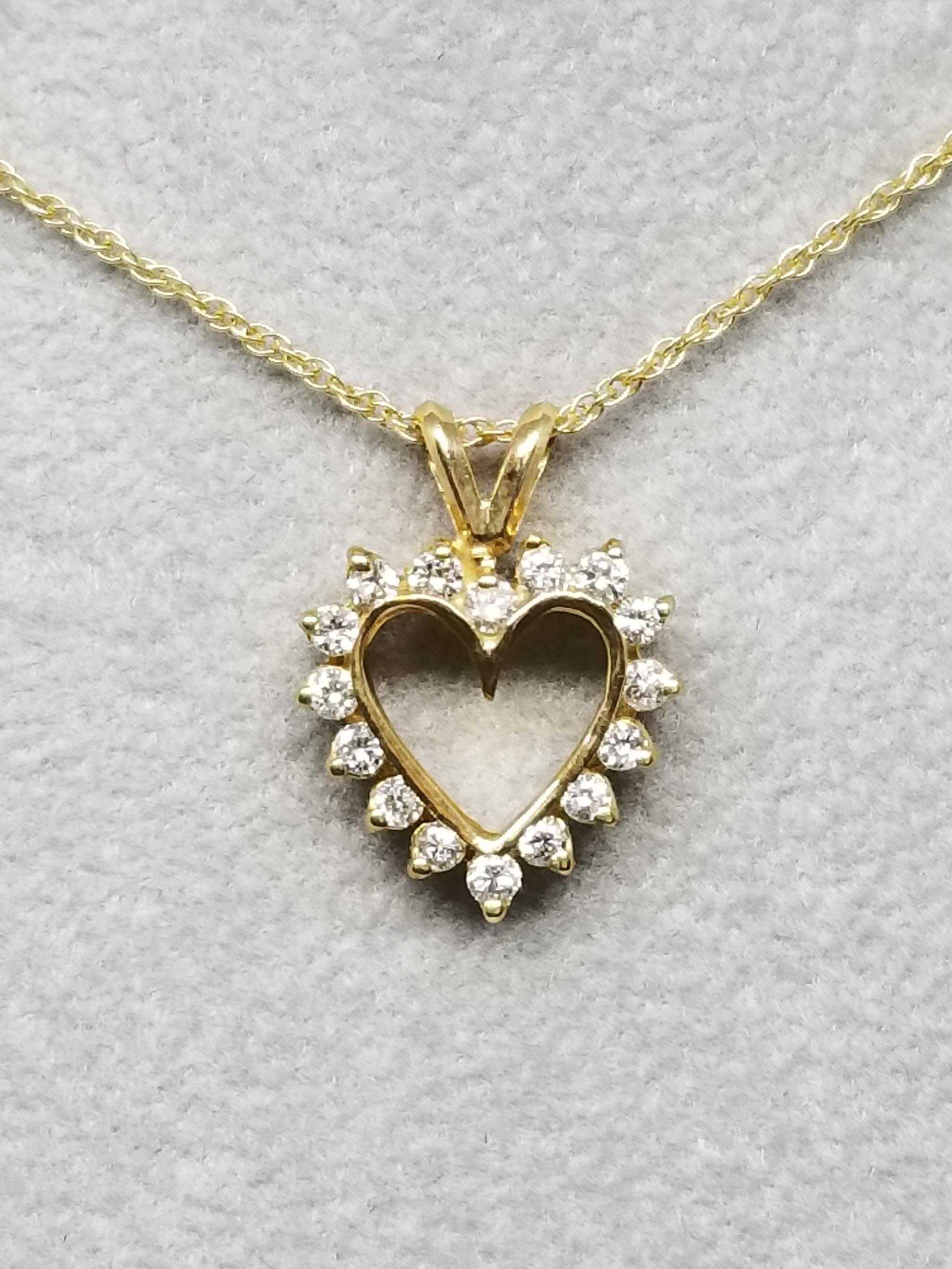 14k yellow gold diamond heart containing 16 round full cut diamonds of very fine quality weighing .35pts.  on a 16 inch chain.