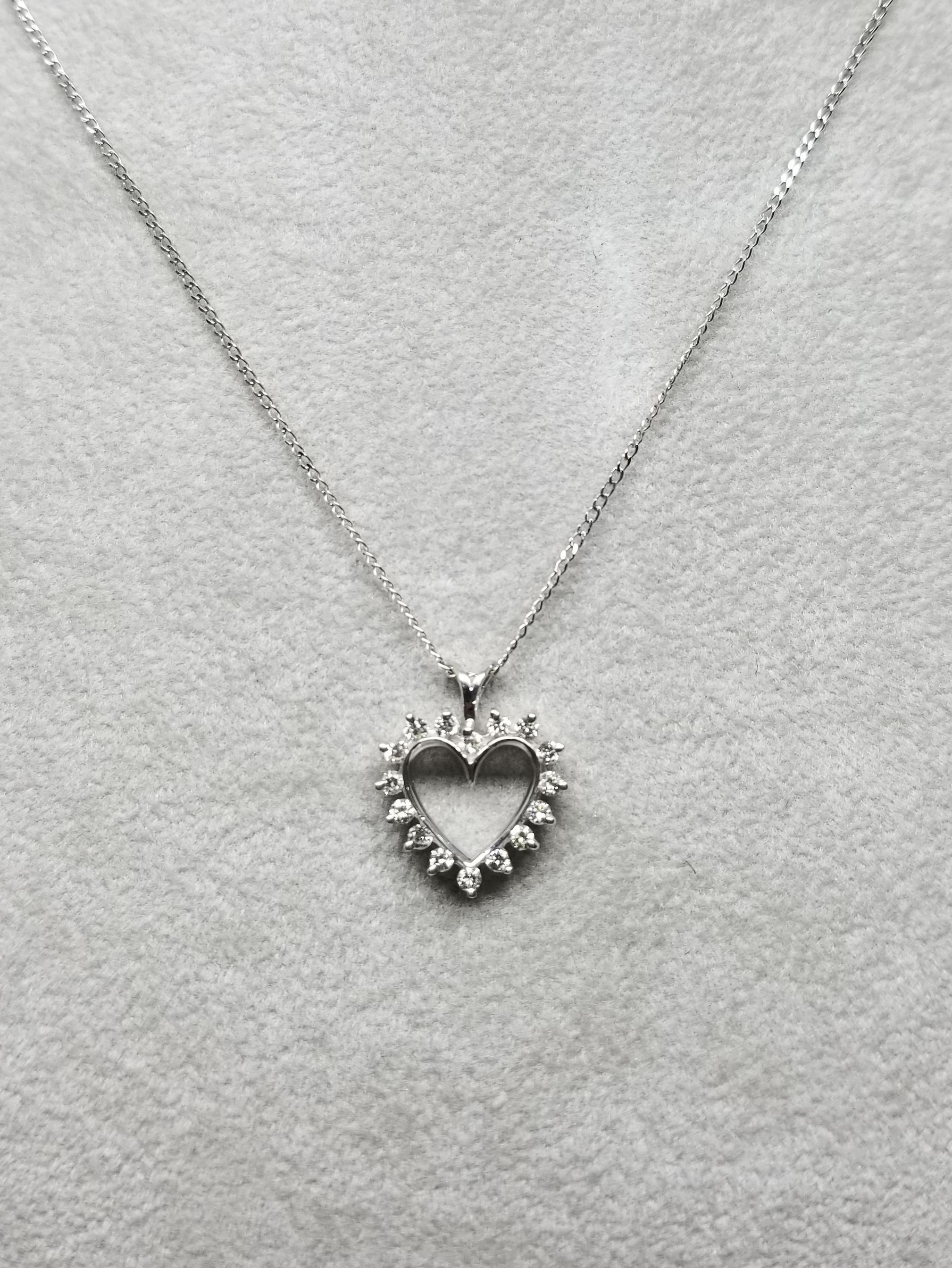 14k white gold diamond heart pendant containing 16 round full cut diamonds of very fine quality weighing .25pts. on a 16 inch chain.