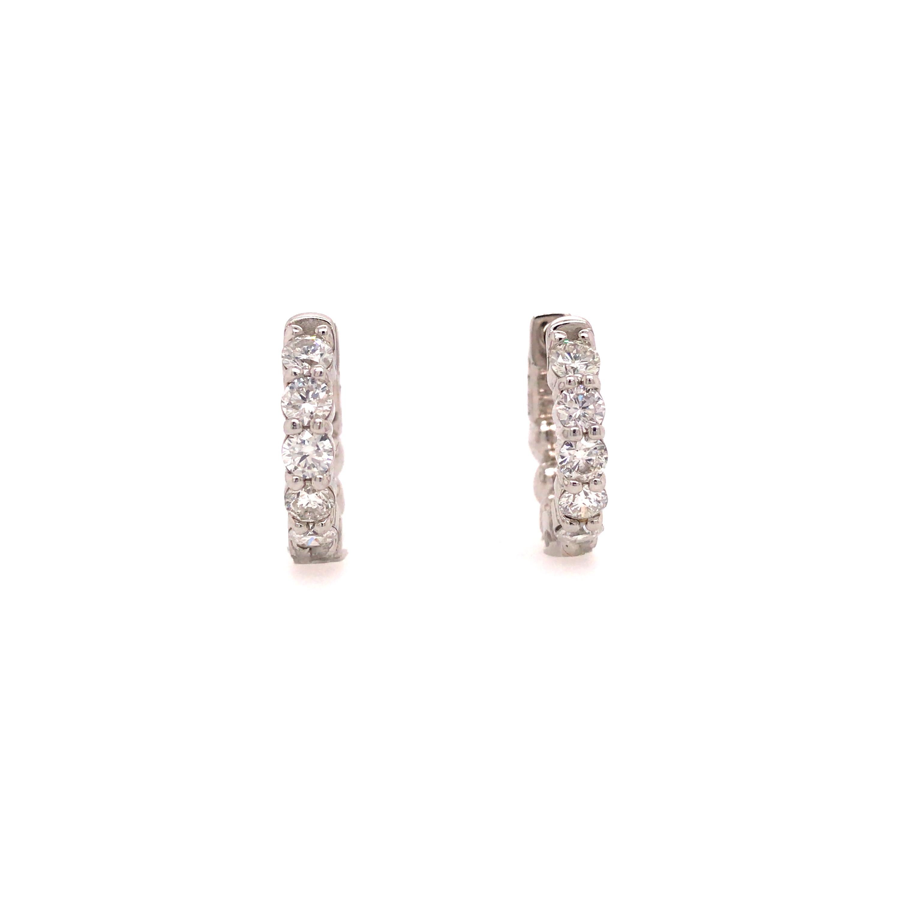 Diamond Huggy Earrings in 14K White Gold.  (10) Round Brilliant Cut Diamonds weighing 1.21 carat total weight, G-H in color and VS-SI in clarity are expertly set.  The Earrings measure 5/8 inch in diameter. 4.66 grams.