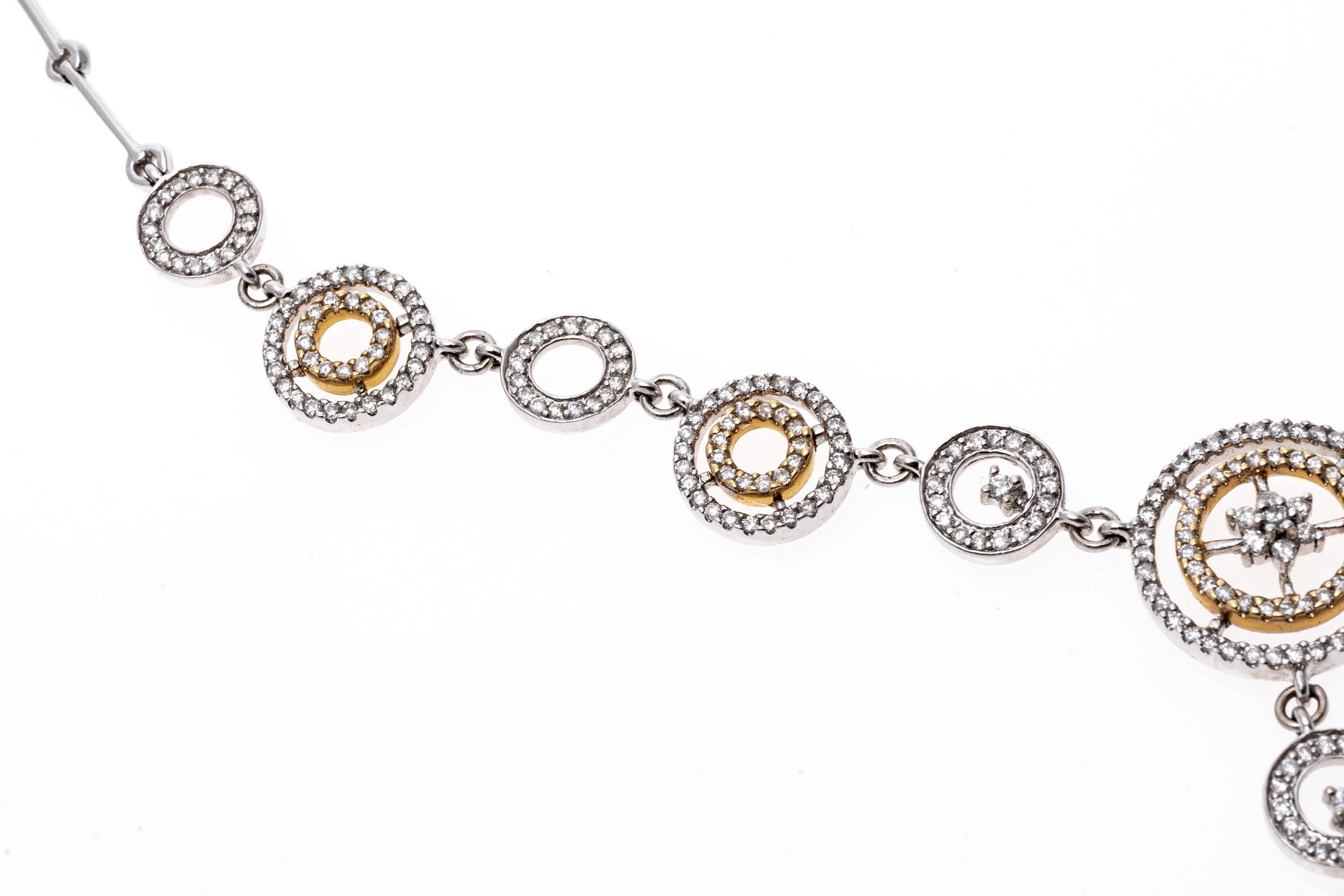 14K White Gold And Diamond Inset Circular Drop Necklace
This glamorous 14K white gold link necklace showcases rings of white and yellow gold. Set within and over the rings are round cut diamonds that create a dazzling shimmer. Suspended from the