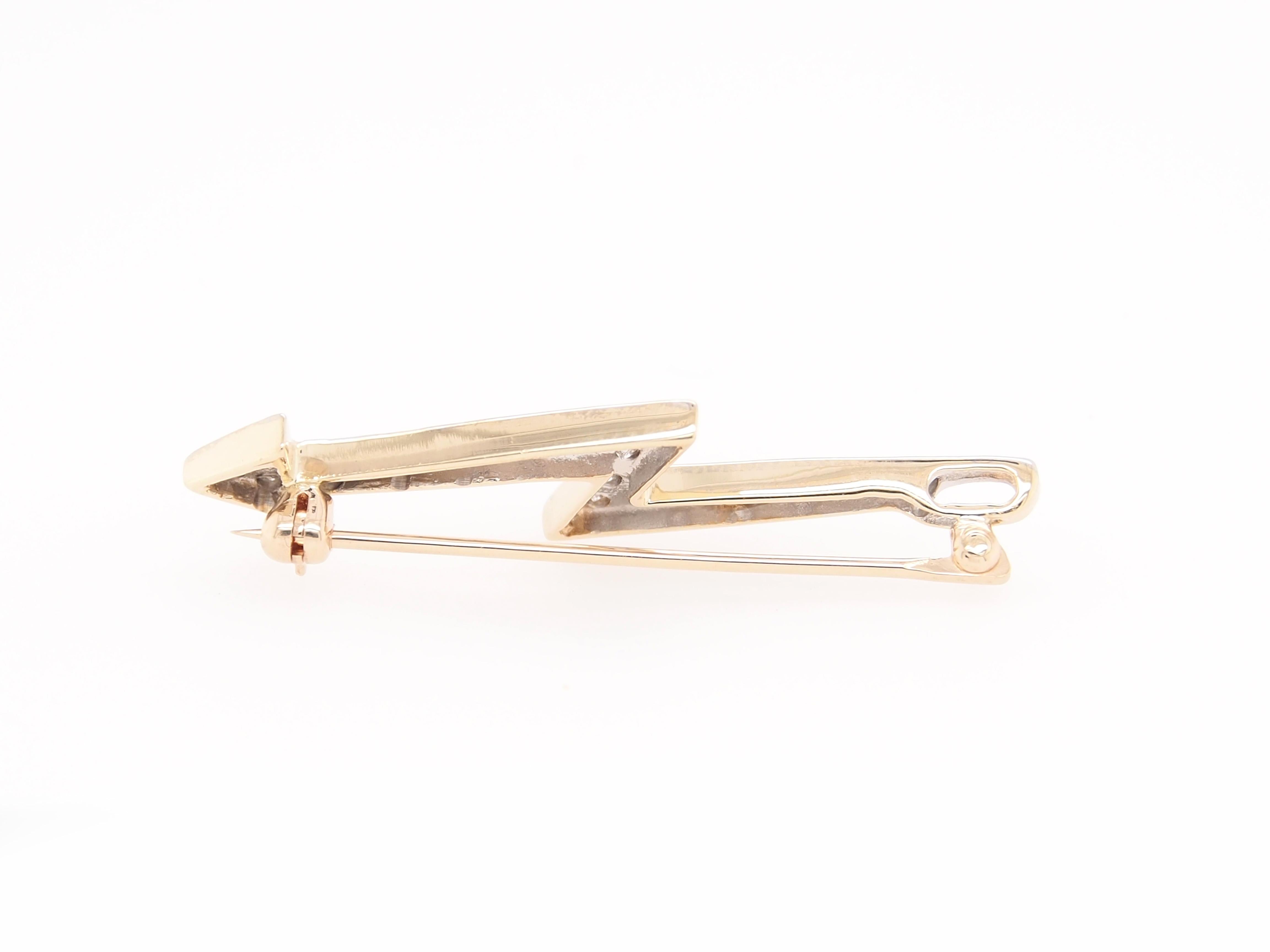 This is a unique Lightening Rod / Arrow Pin. (17) Round Brilliant Diamonds G-H in color, VS-SI in clarity and approximately .36 carat total weight are prong set in 14K two tone gold. The diamonds are set in white gold and framed with yellow gold