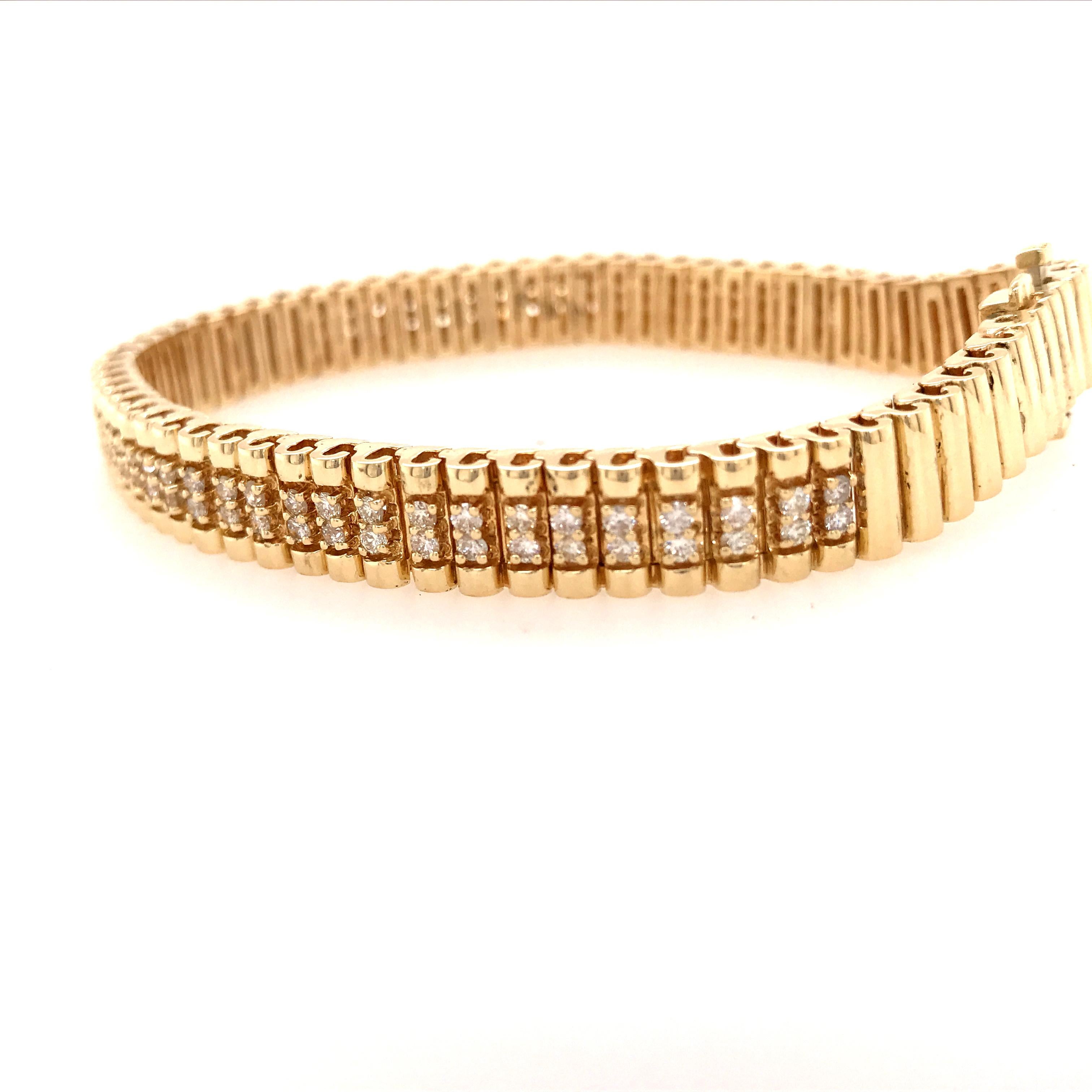 Diamond Line Bracelet in 14K Yellow Gold.  (50) Round Brilliant Cut Diamonds weighing 1.25 carat total weight G-H in color and VS-SI in clarity are expertly set.  The Bracelet measures 7 1/2 inch in length and 5/16 inch in width. 37.32 grams.