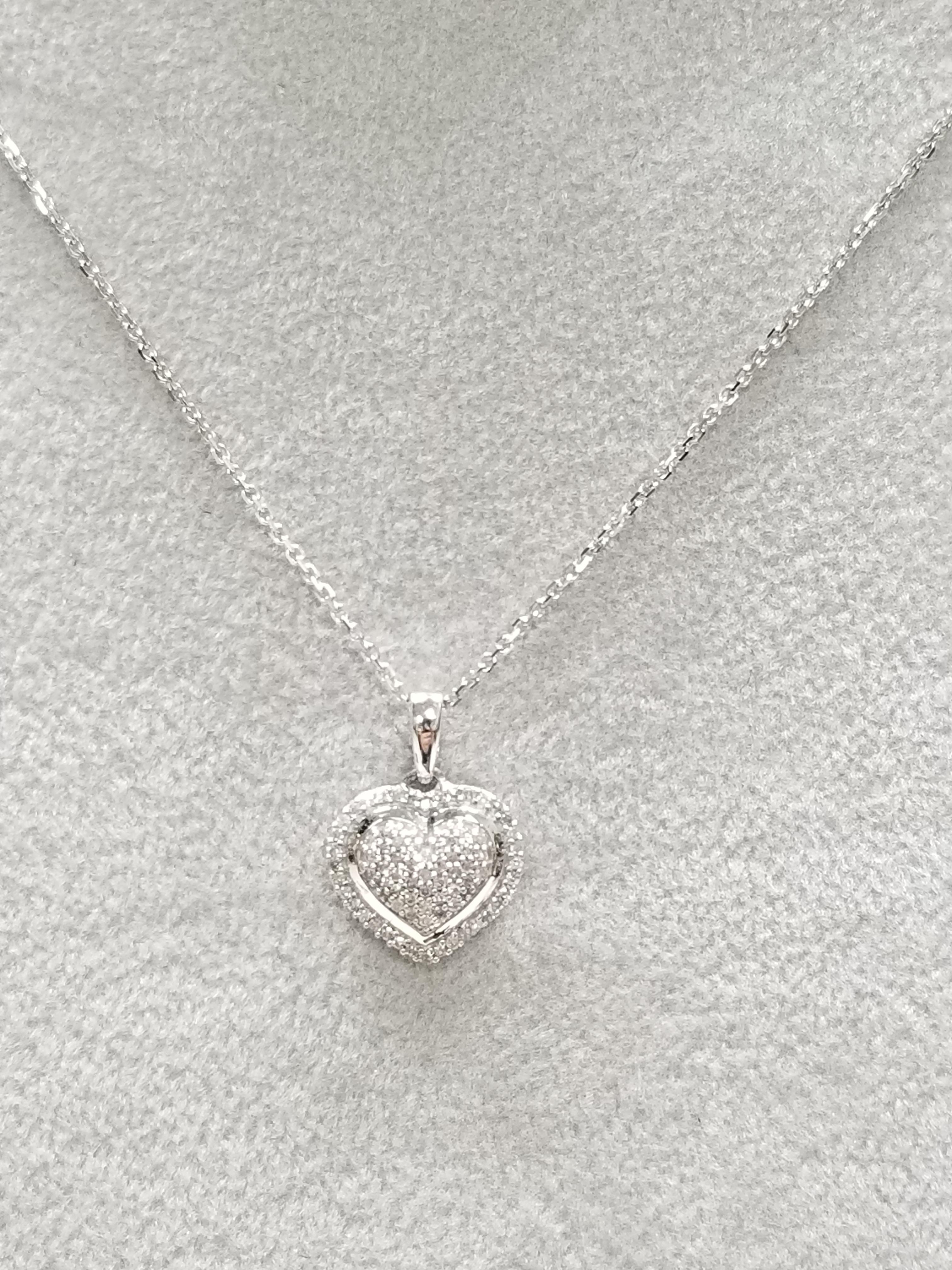 14k white gold diamond pave' set heart containing 77 round diamonds of very fine quality weighing .40pts. on a 16 inch chain.