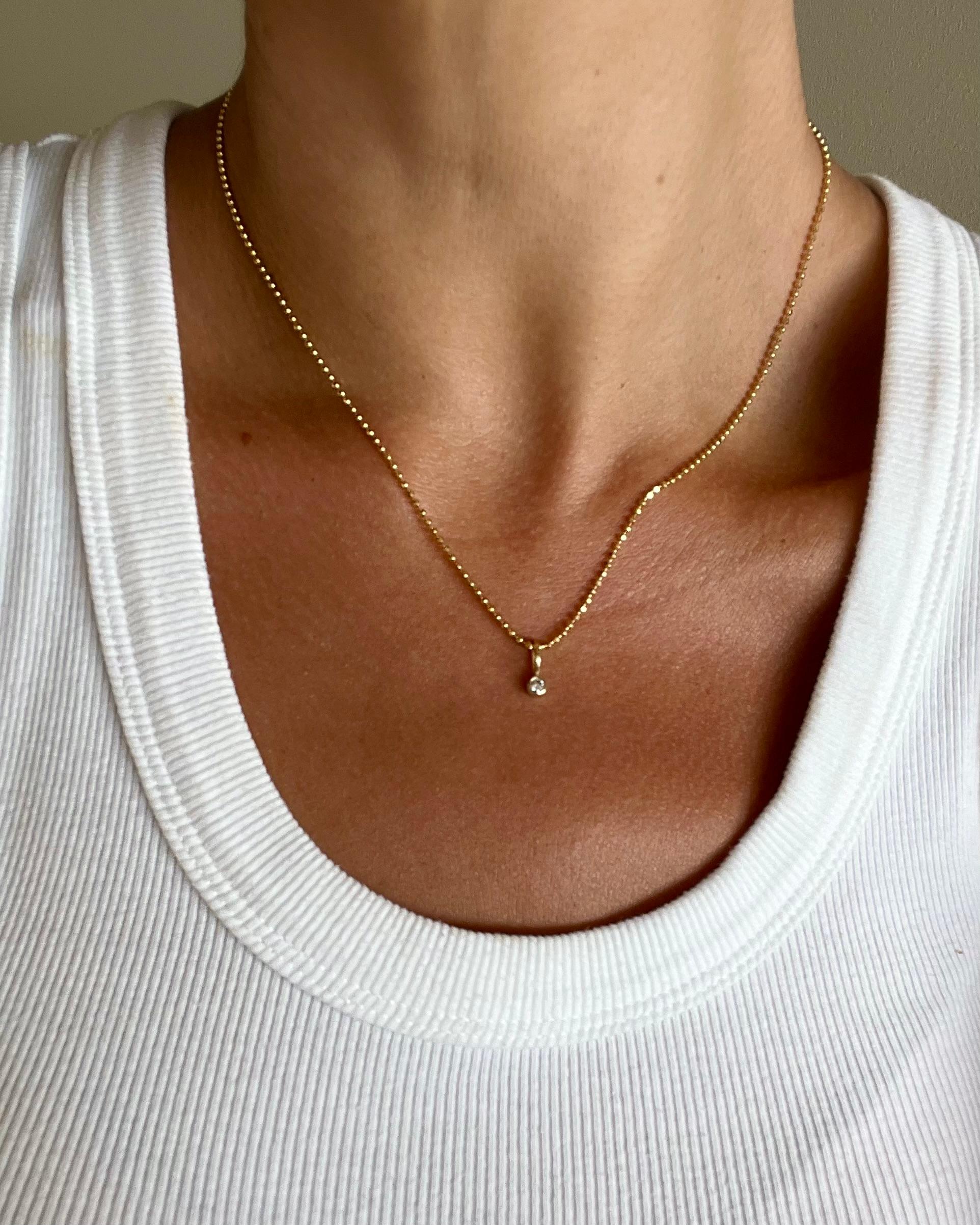 LIMITED TIME SUMMER SALE

Meticulously crafted from solid 14k gold, this diamond-cut ball chain and natural diamond pendant captivates with its intricate faceting that catches and reflects light with every subtle movement. Paired with our signature