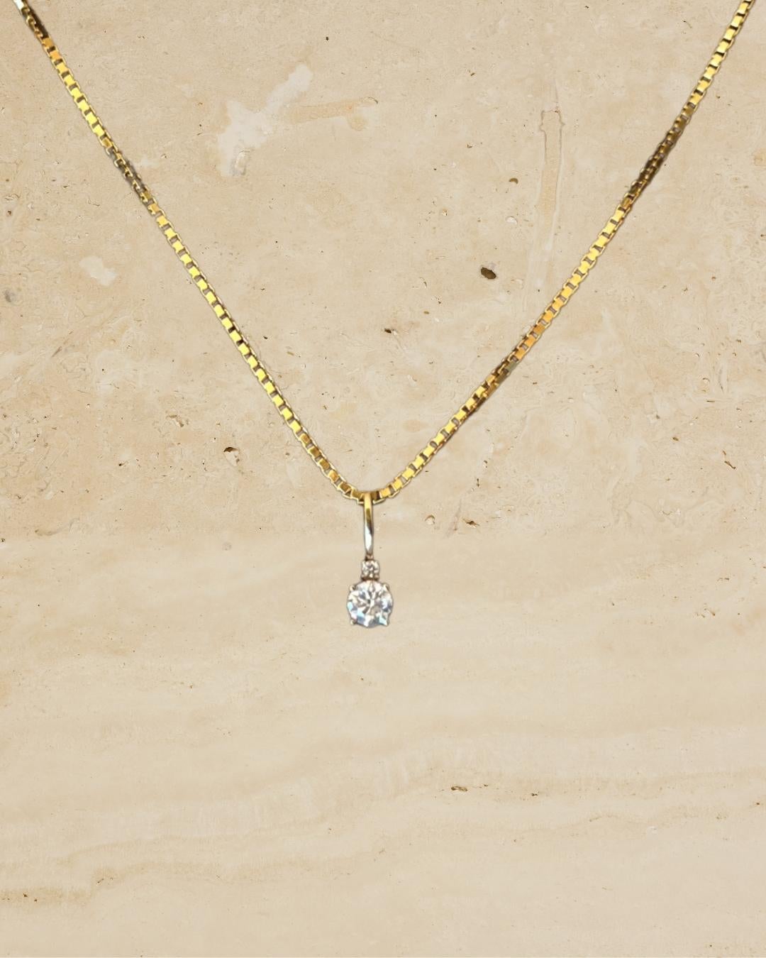 Exquisitely constructed from solid 14k yellow gold, this timeless box chain is elevated by our signature hand-pavé double-sided natural diamond clasp and double diamond pendant—a true statement of timeless elegance. Designed to seamlessly enhance