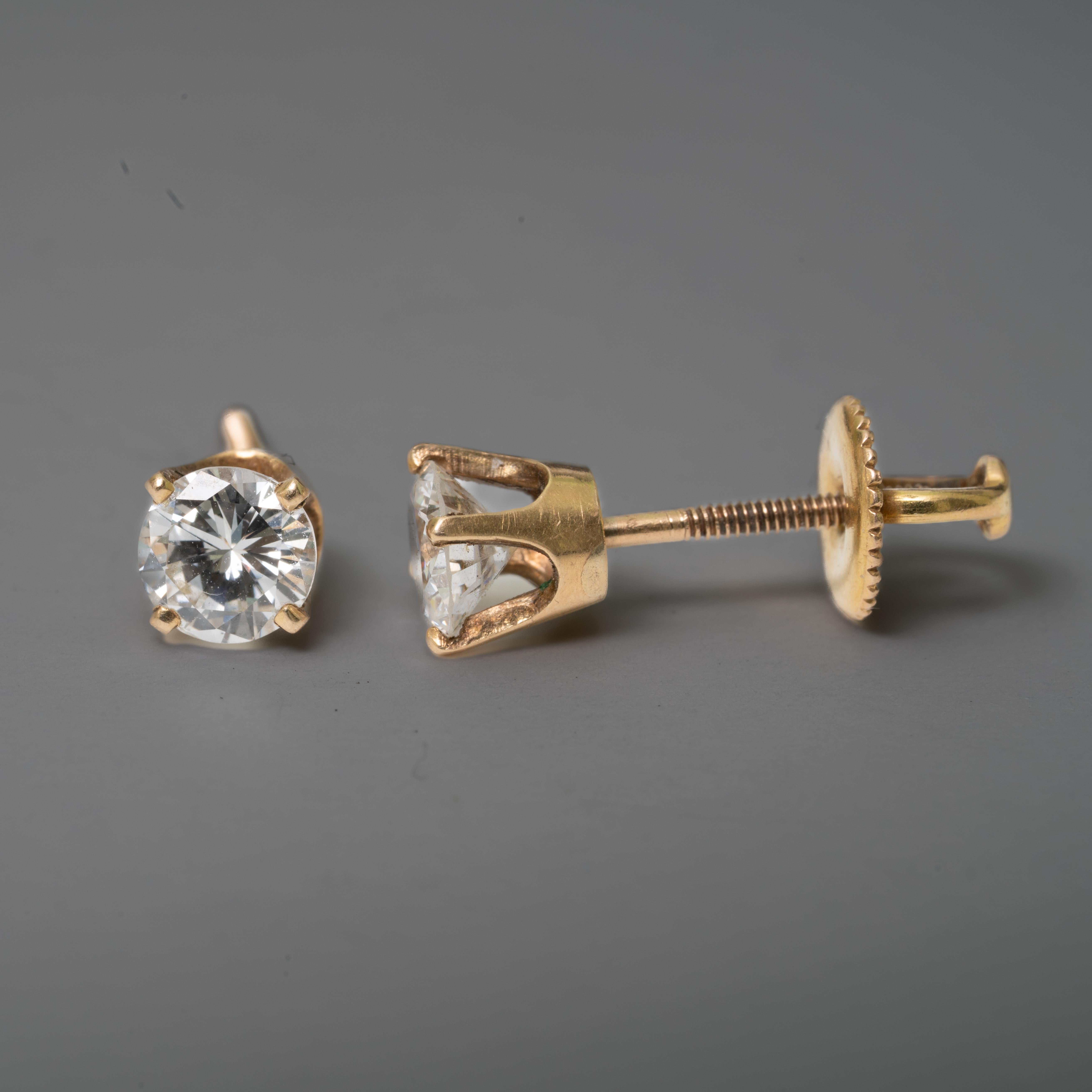 14k diamond studs, 1 dwt. The diamonds are approximately .48ct each, with a VS1 clarity and a K color.