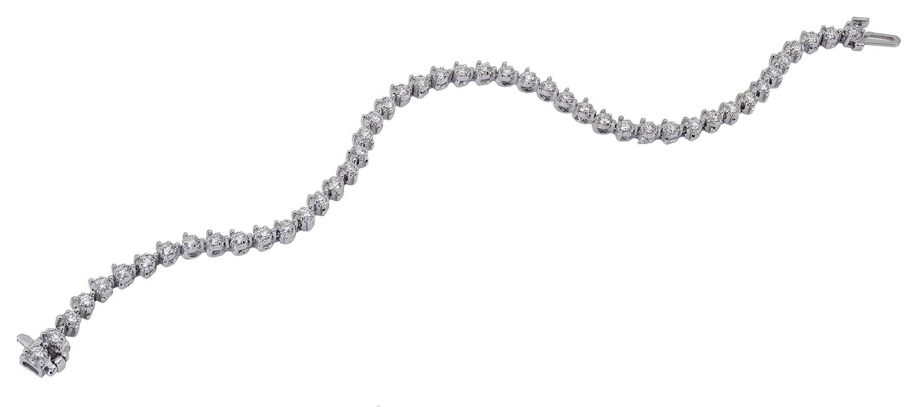  A classic Diamond Tennis bracelet stylized in a 3 prong setting. There are 46 round diamonds weighing 1.50 carats in total, set in 14K white gold material with a box clasp closure. 

This bracelet measures 7 inches long.