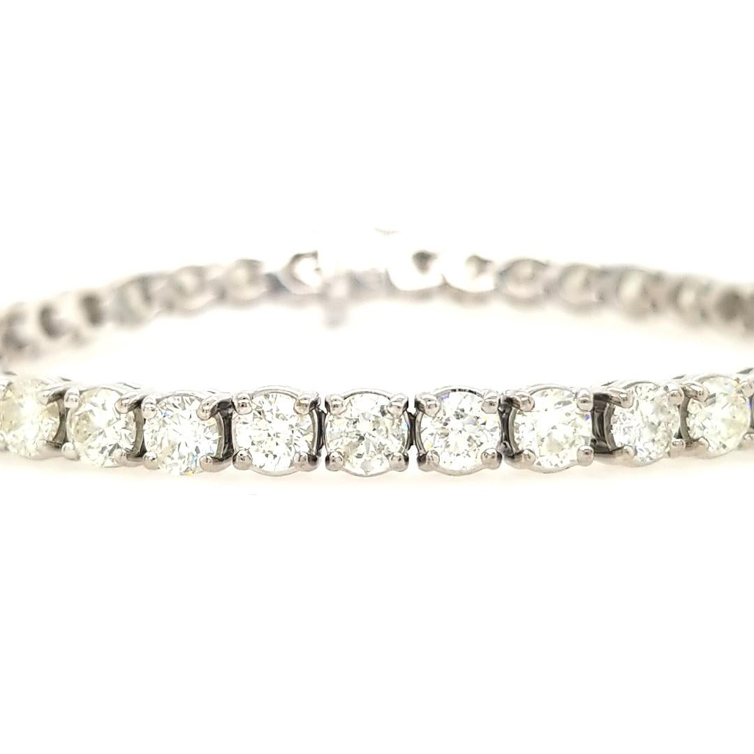 Diamond Tennis Bracelet in 14K White Gold.  (39) Round Brilliant Cut Diamonds 10.88 carat total weight, H-J in color and SI-I1 are expertly prong set in baskets.  The bracelet measures 7 1/4 inch in length, 3/8 inch in width and weighs 23.7 grams.